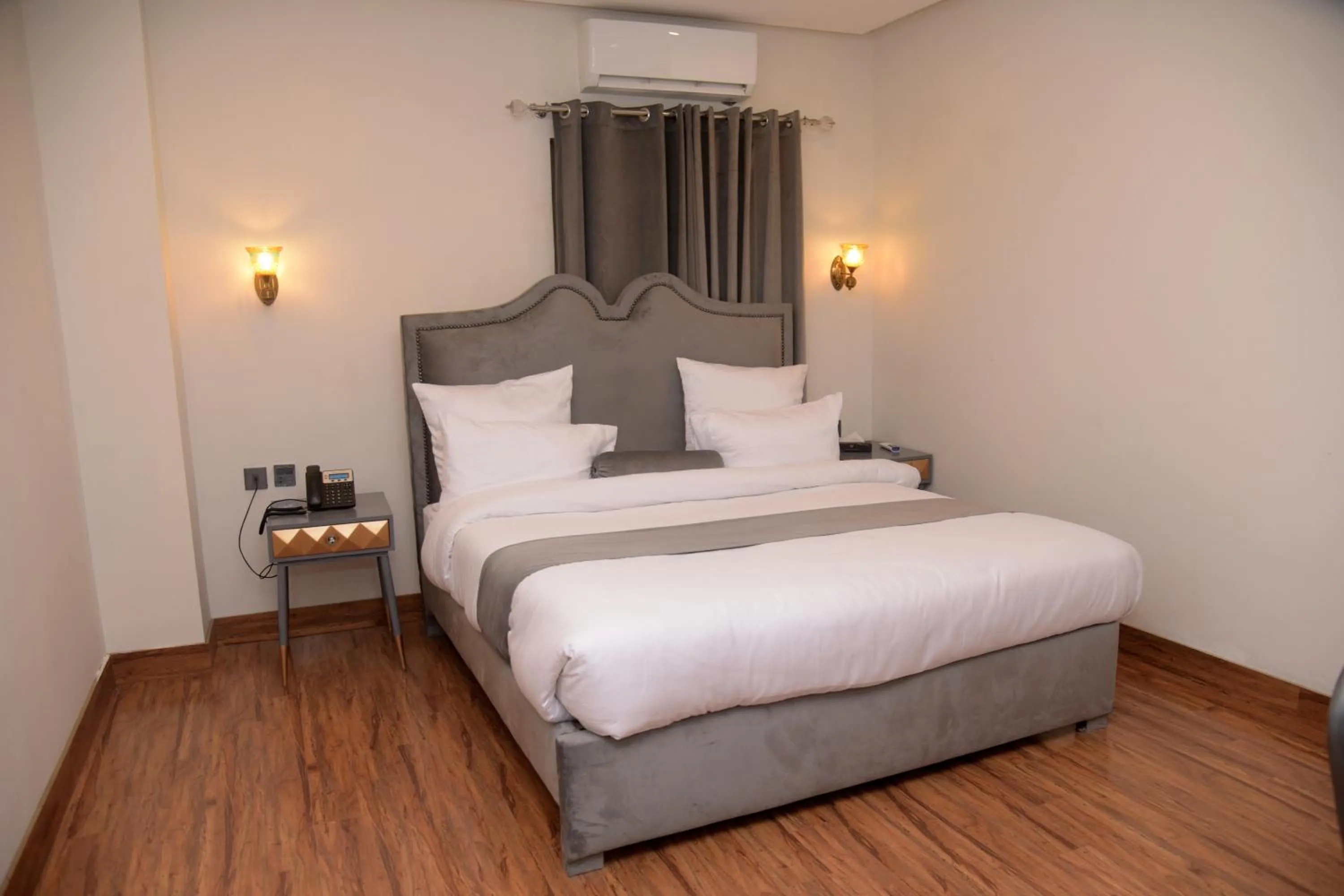 Bed in The Rich Hotel & Apartments