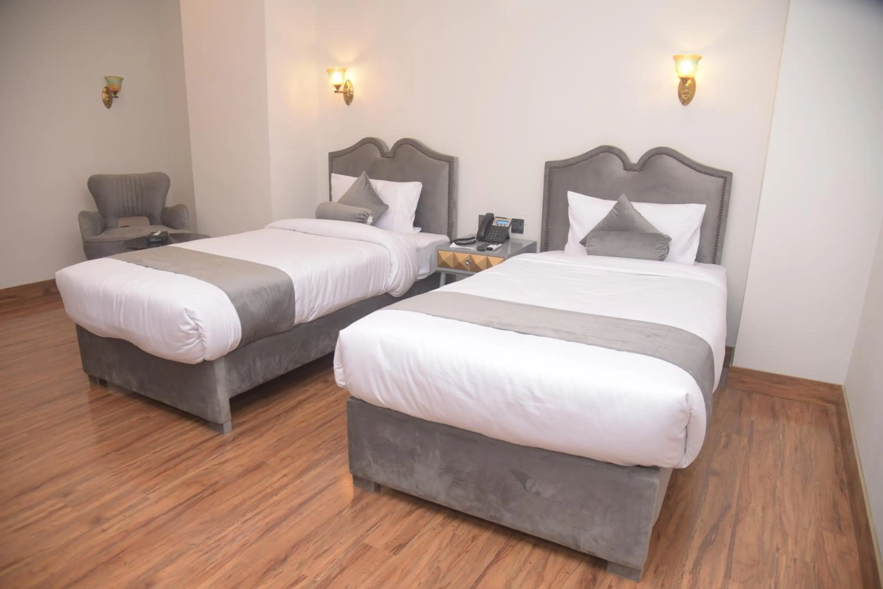 Bed in The Rich Hotel & Apartments