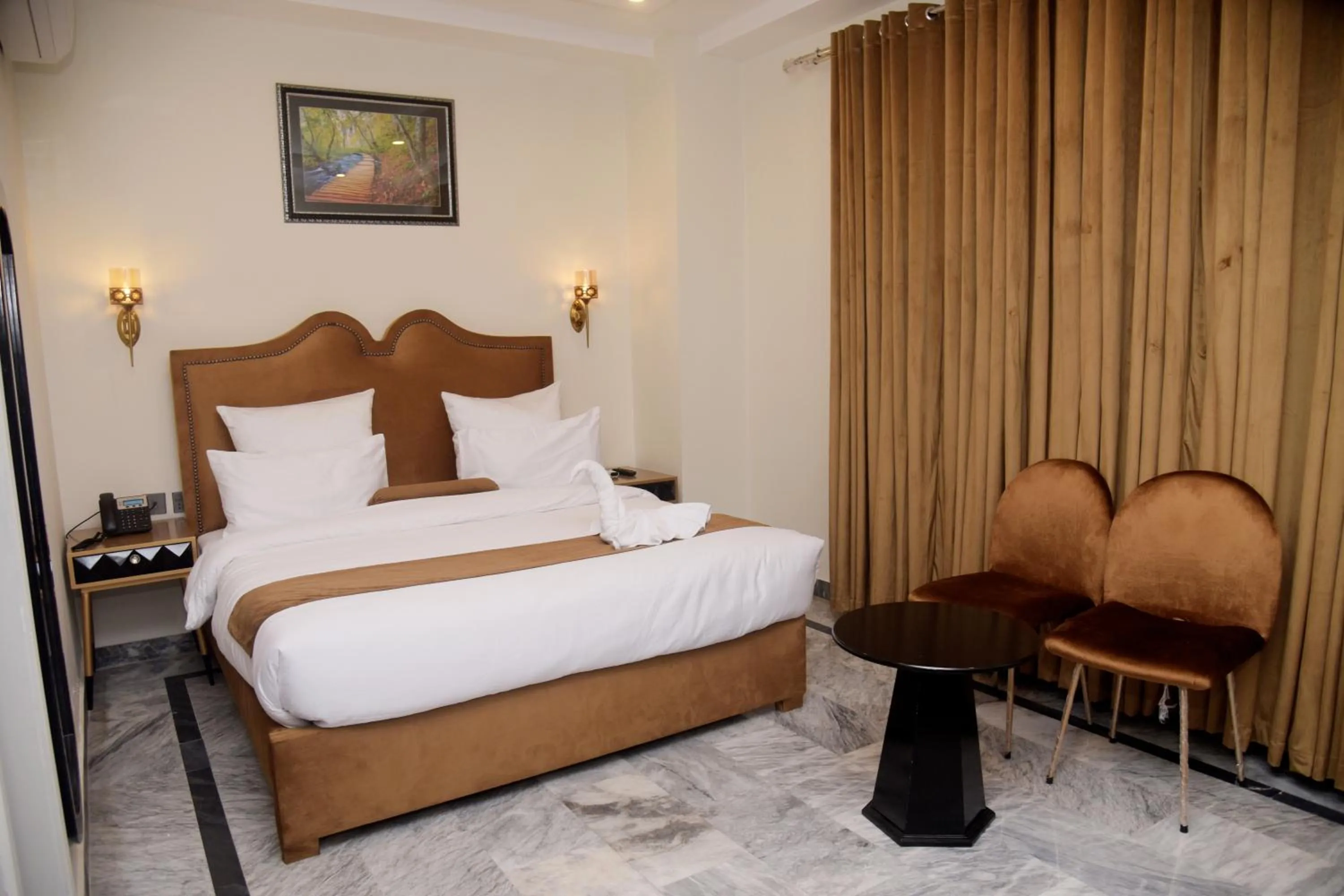 Bed in The Rich Hotel & Apartments