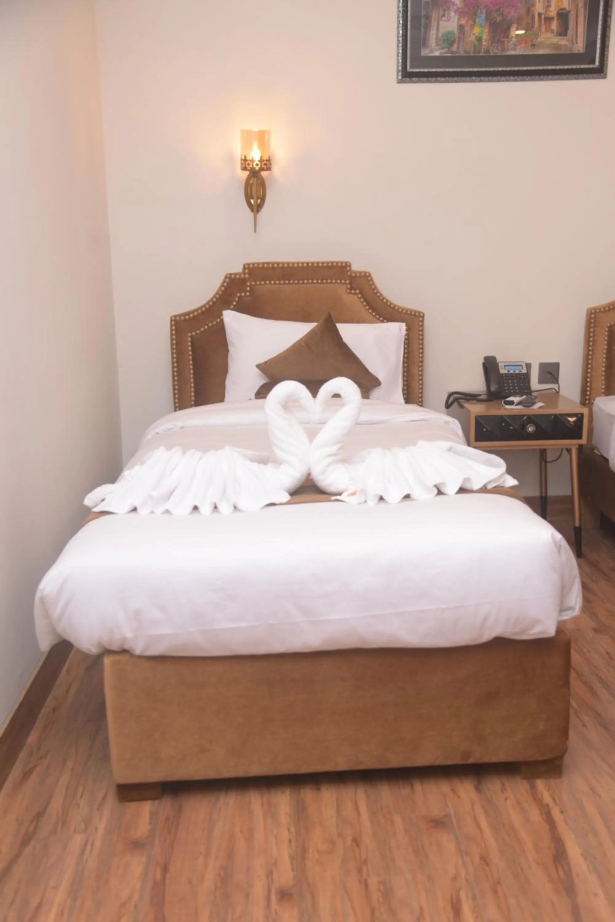 Bed in The Rich Hotel & Apartments