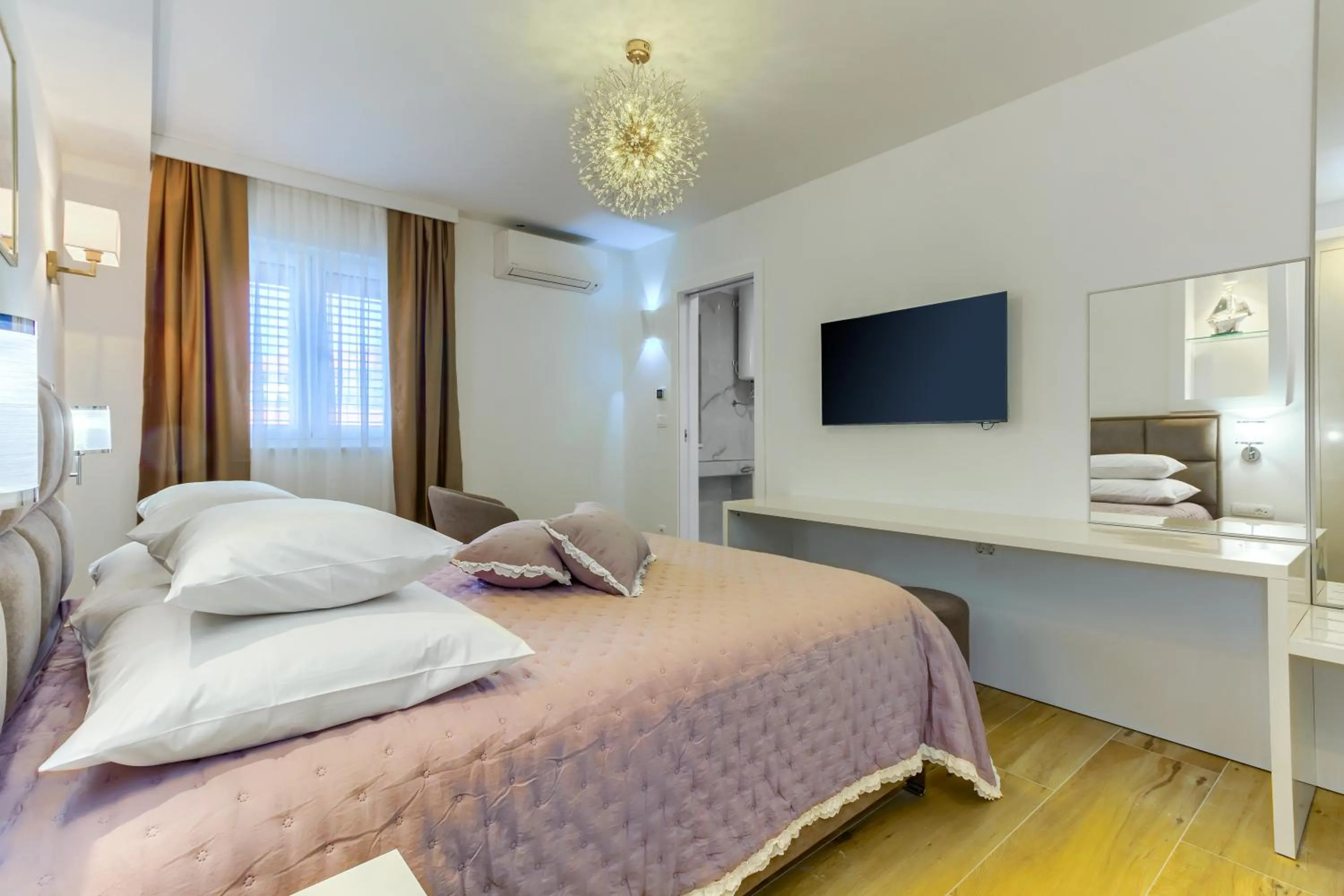 Bed in Irini Luxury Rooms