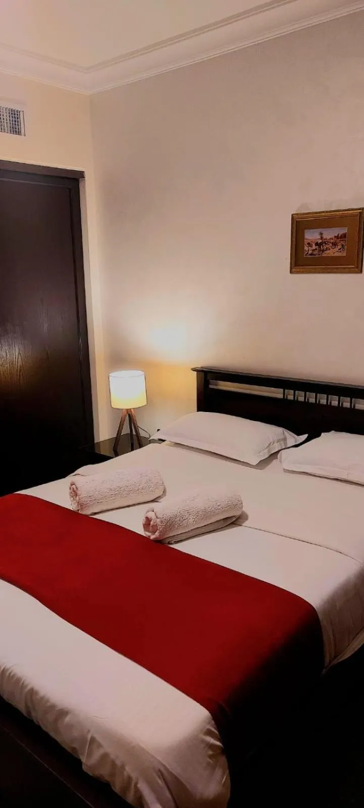 Bed in Tamrah Suites Hotel
