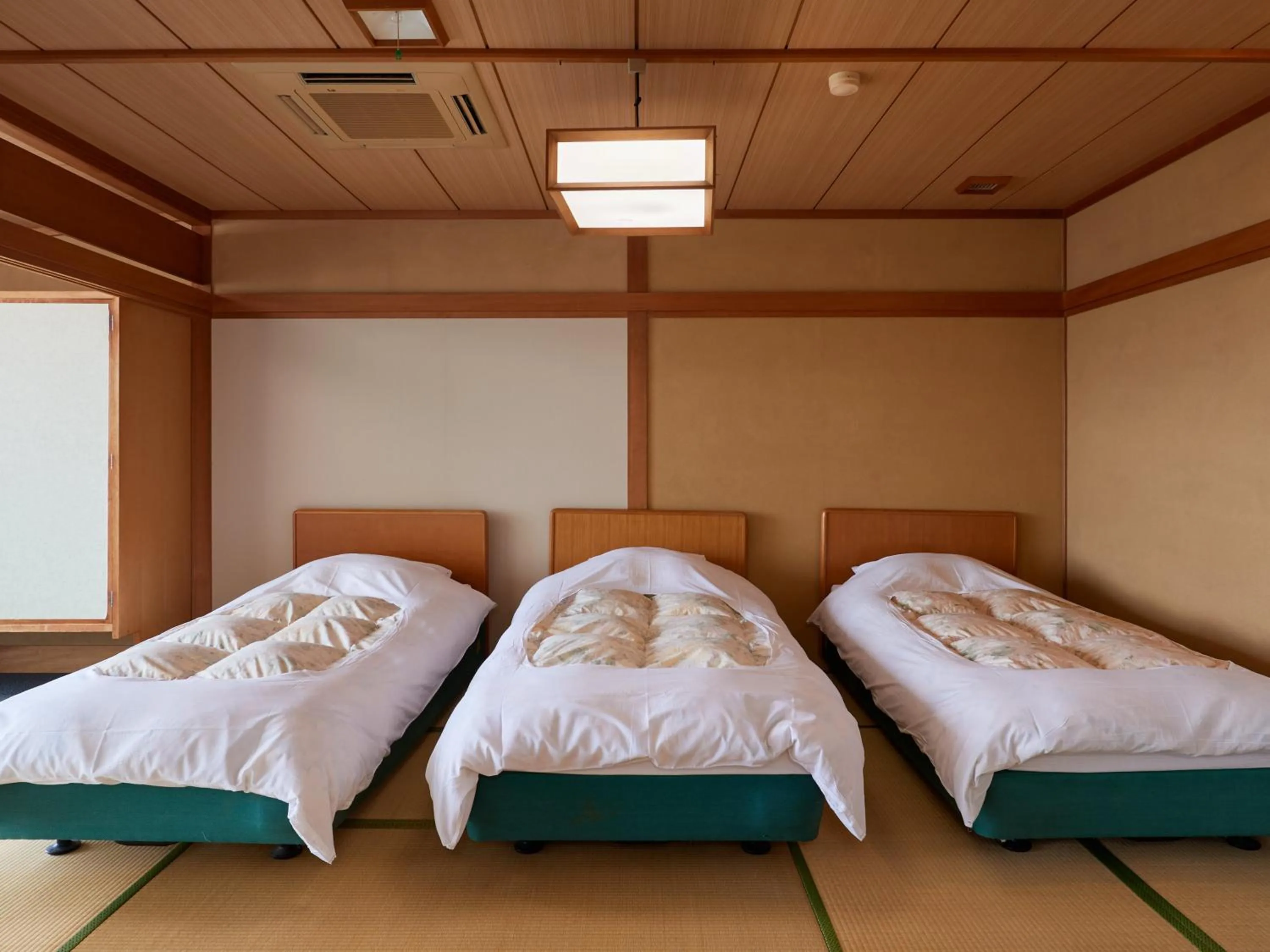 Bed in Izu Atagawa Onsen Hotel Gyokuryu