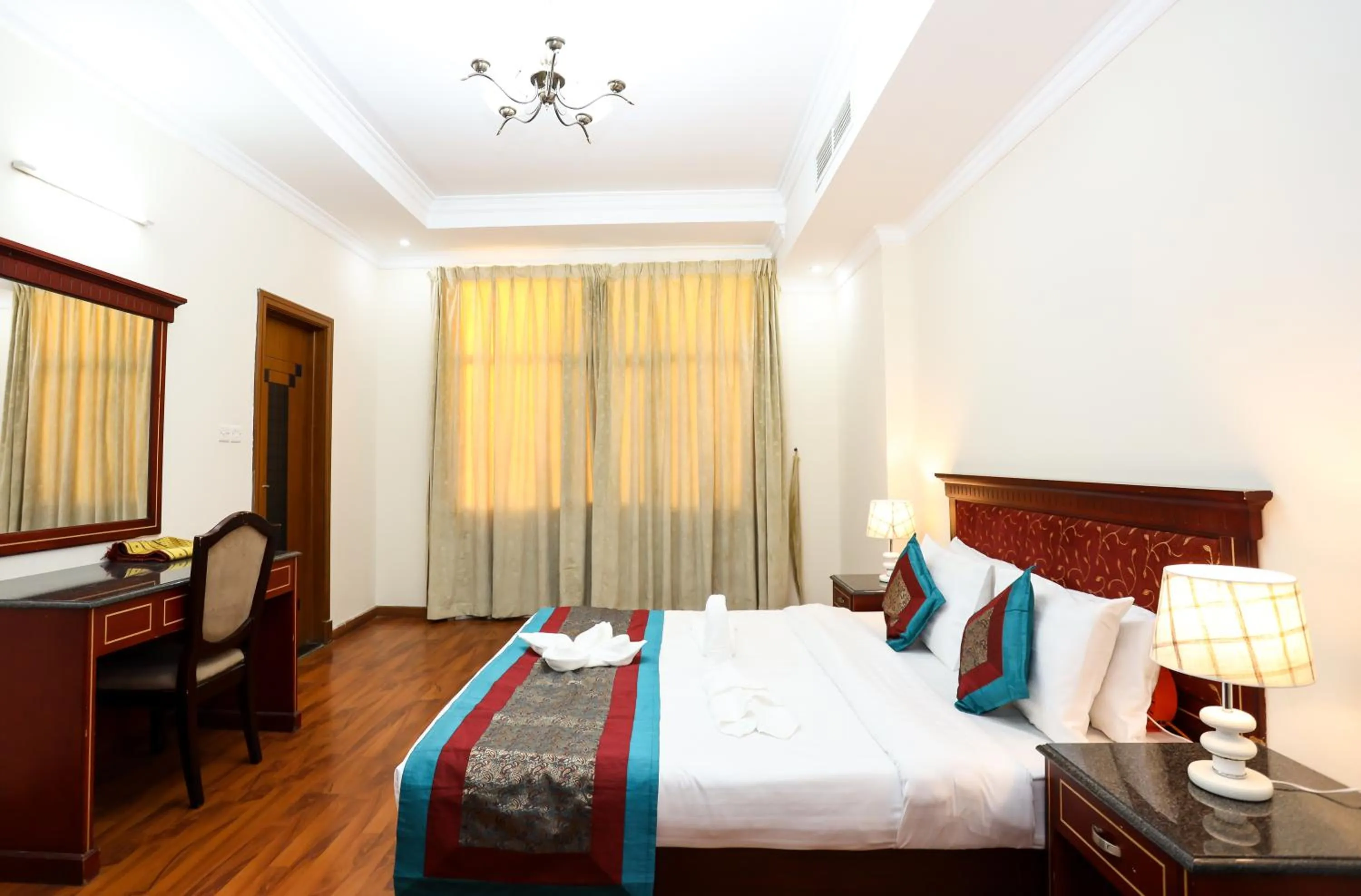 Seating area, Bed in Pearl Bahrain Suites