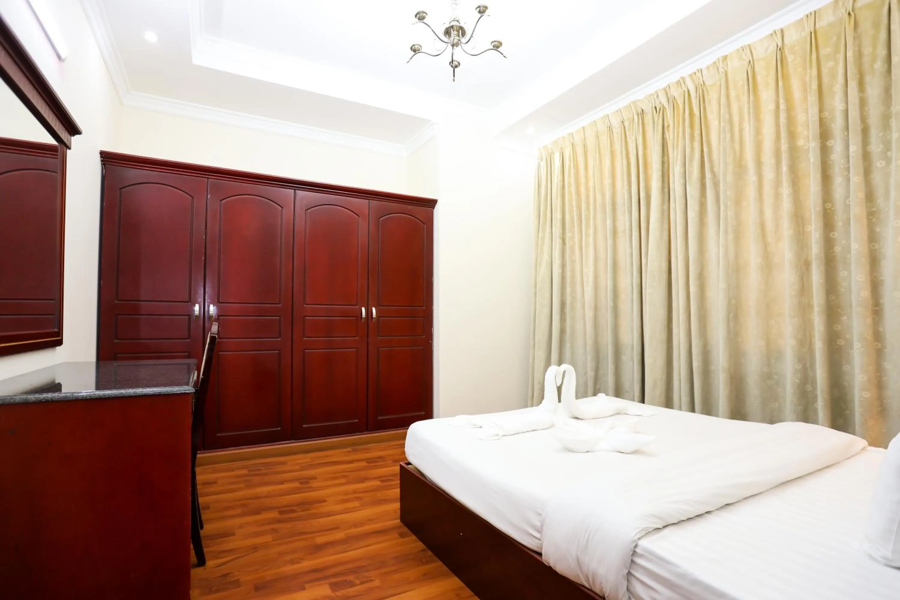 Bed in Pearl Bahrain Suites