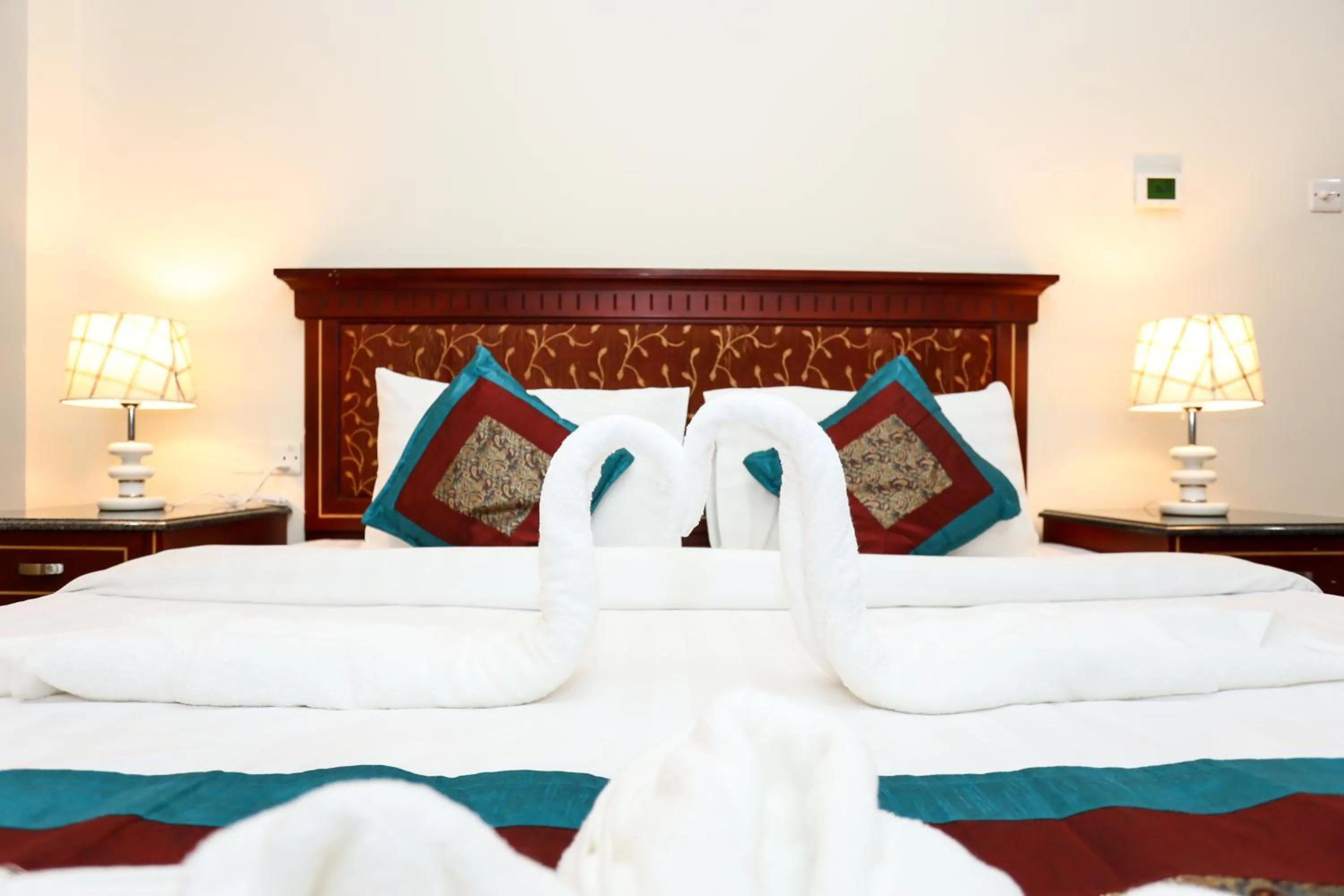 Bed in Pearl Bahrain Suites