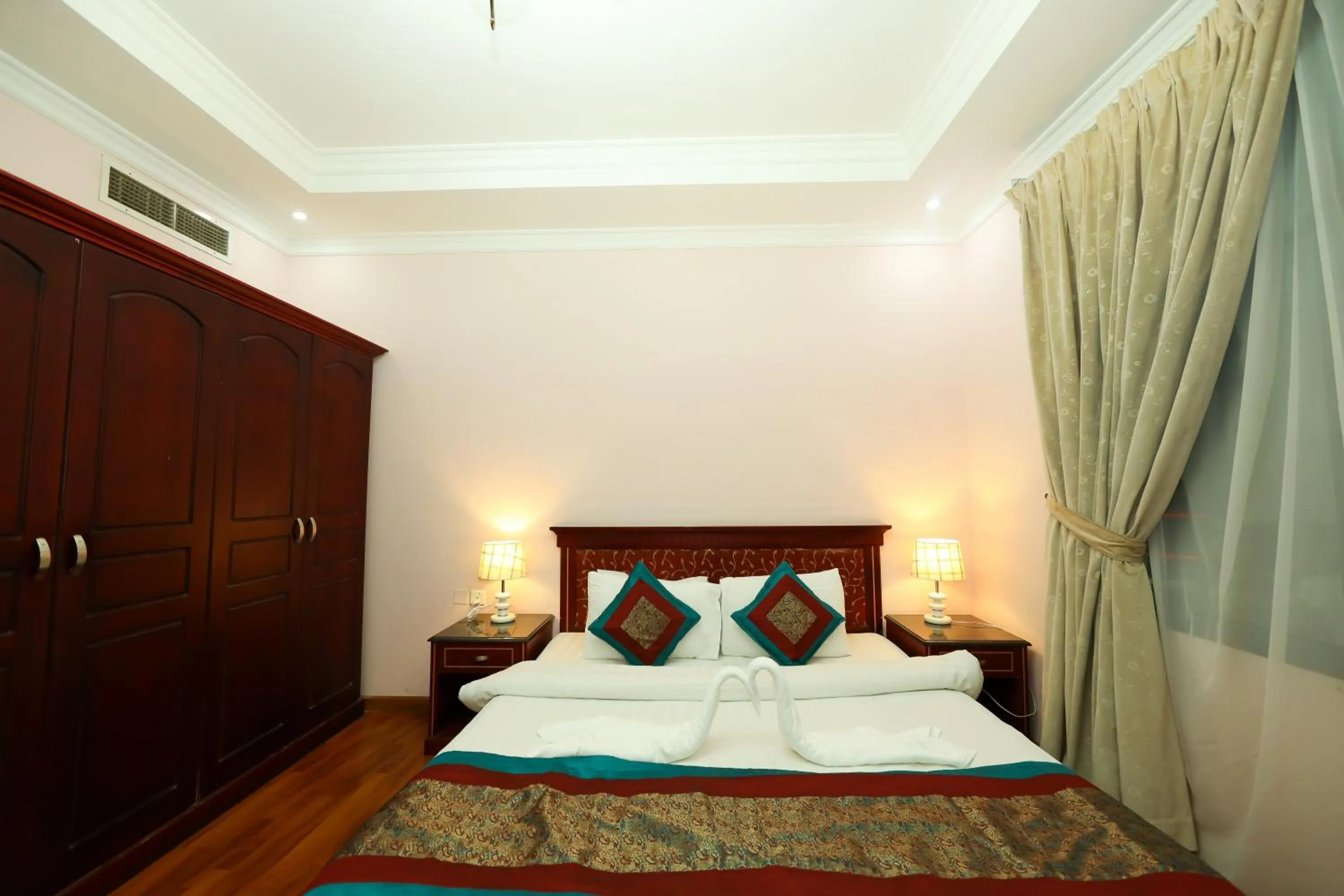 Bed in Pearl Bahrain Suites