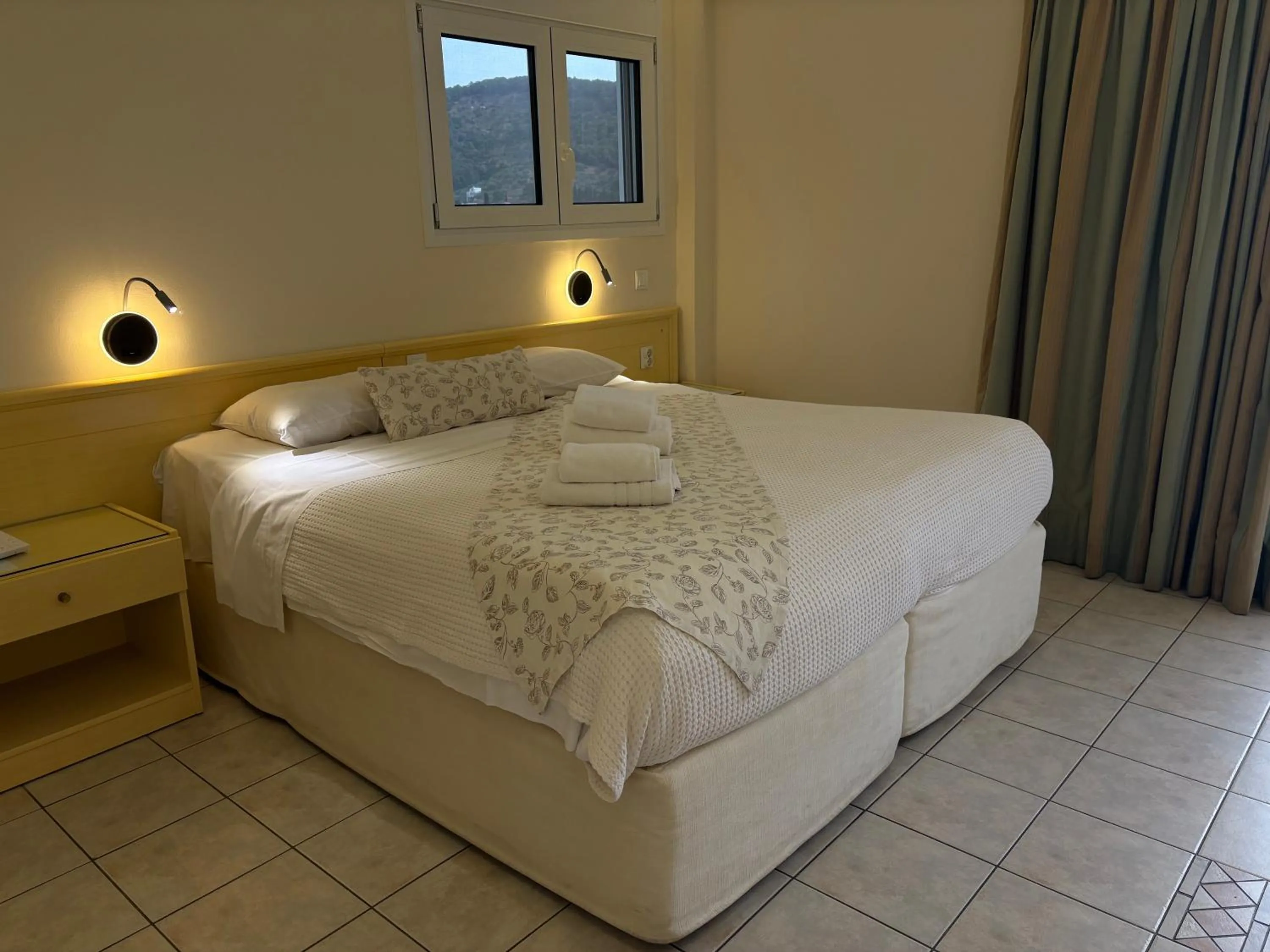Bed in New Aegli Resort Hotel