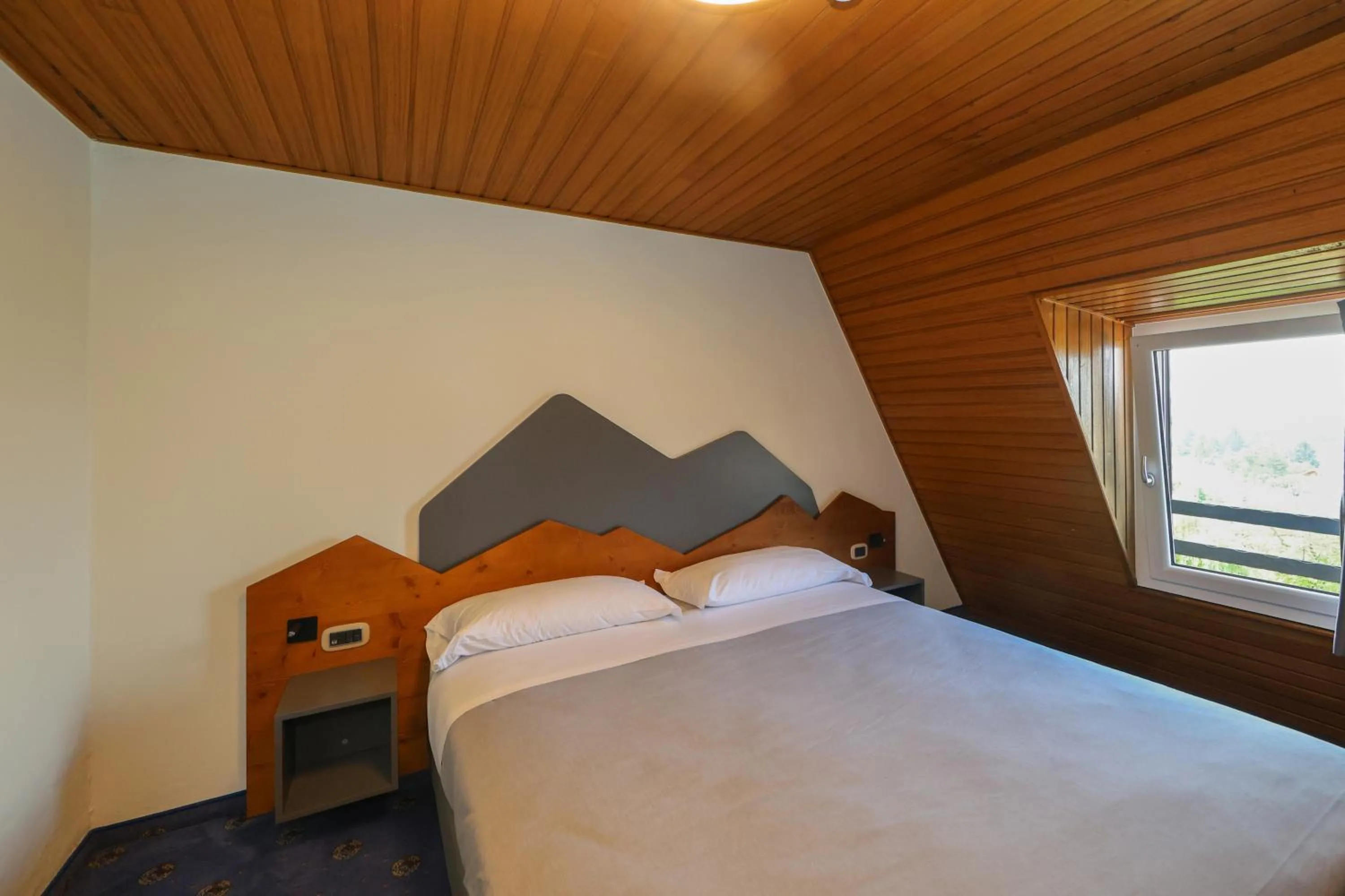 Bed in Hotel Regina del Bosco