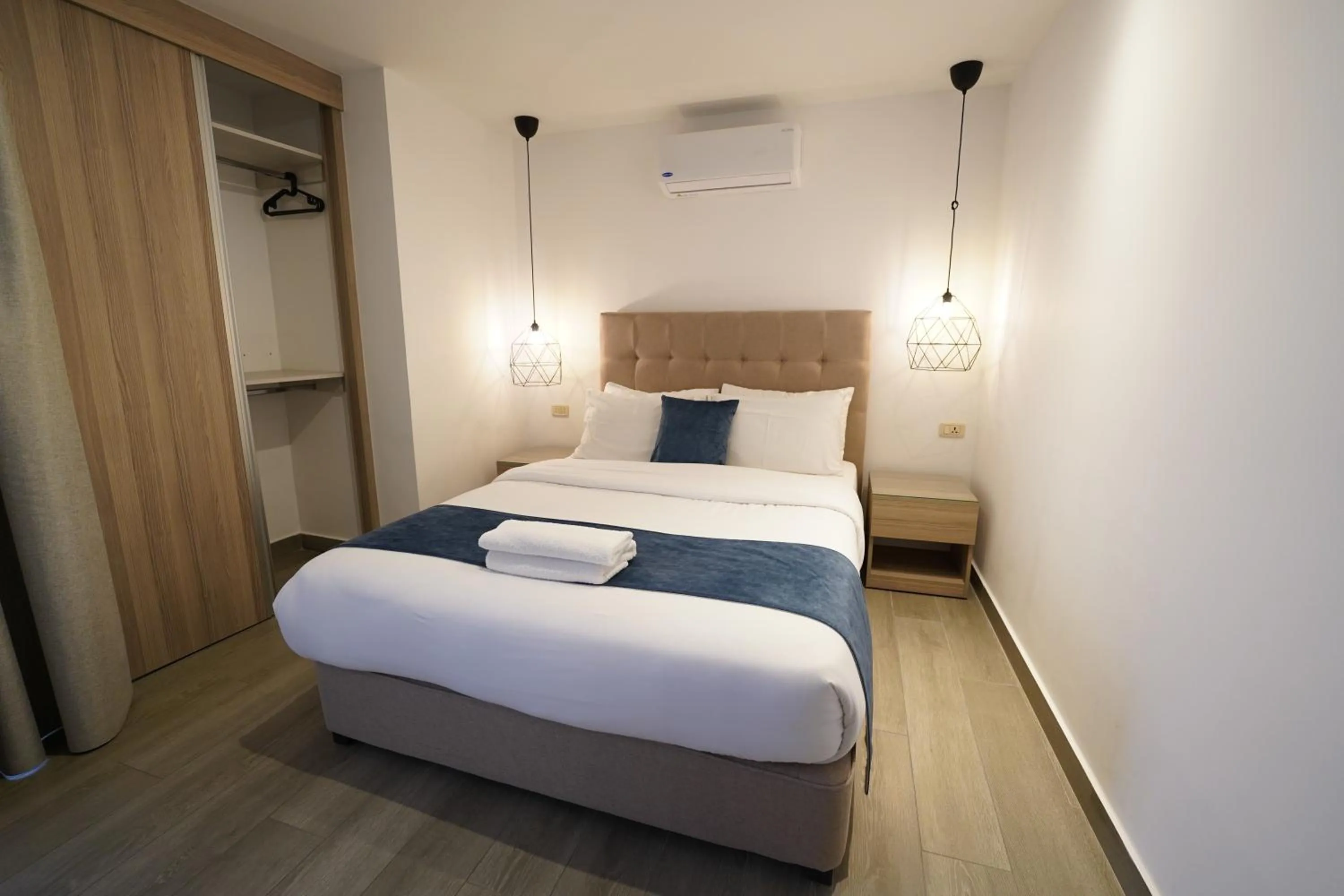 Bed in Red Carpet Hotel & Suites