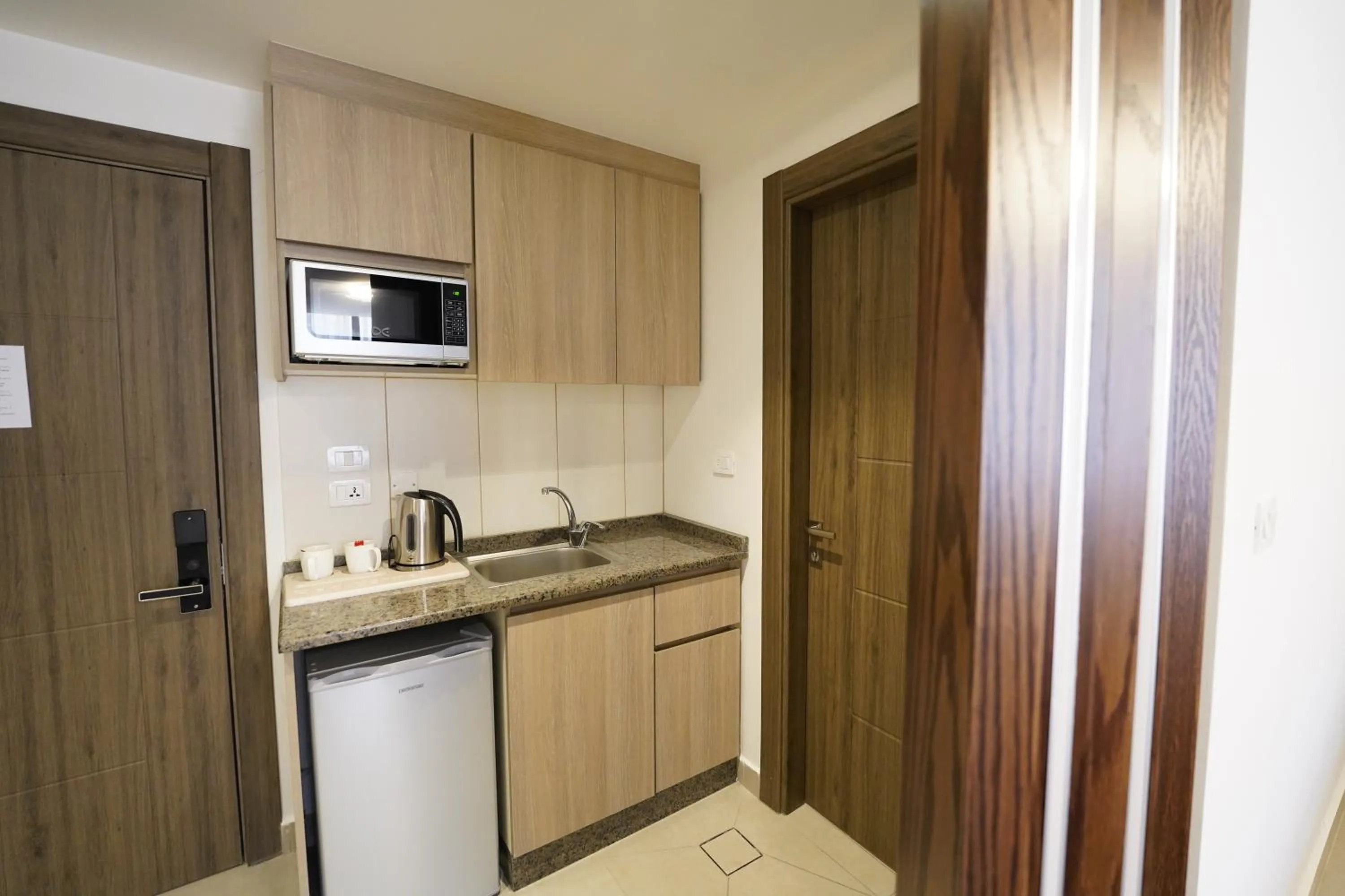 Kitchen or kitchenette in Red Carpet Hotel & Suites