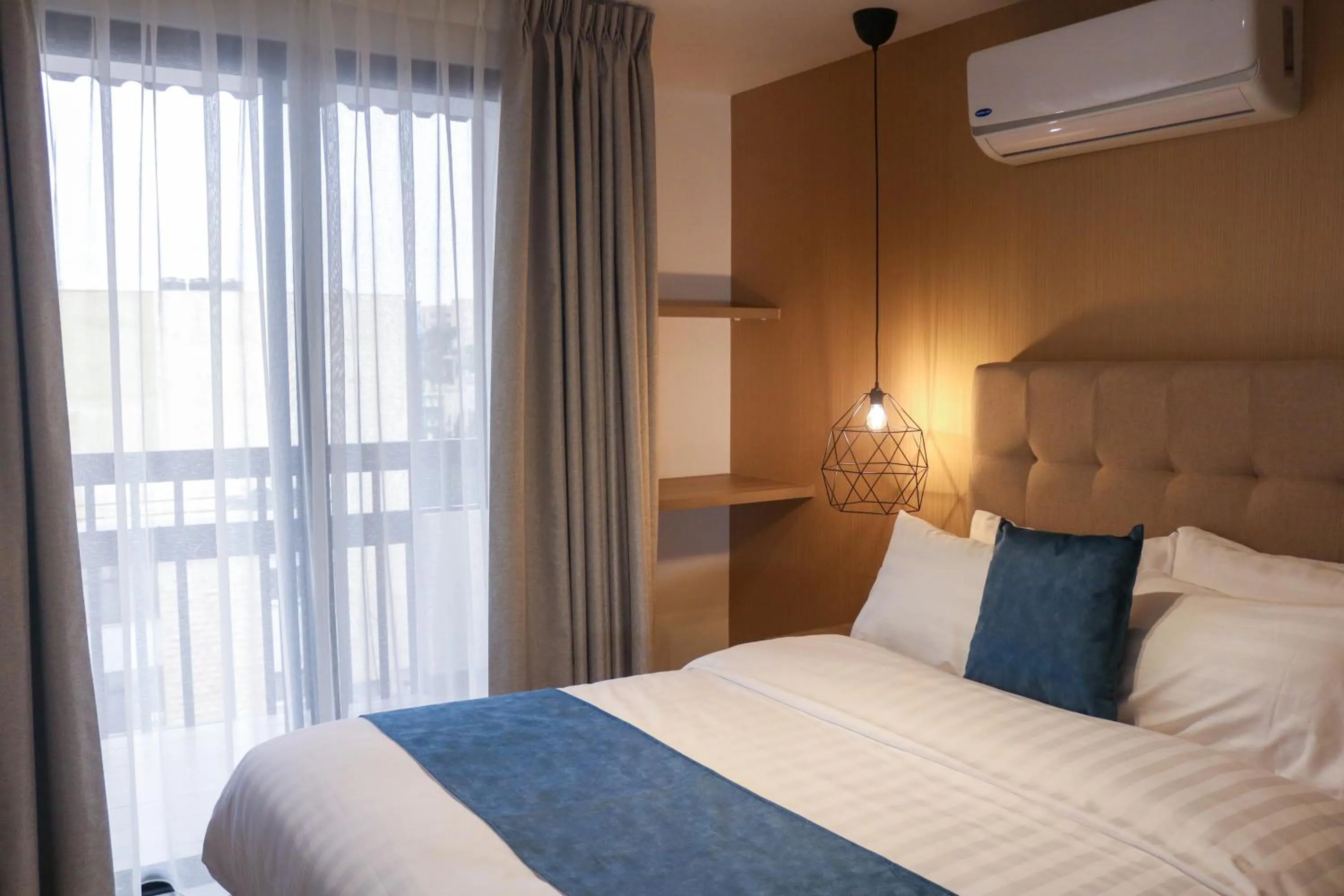 Bed in Red Carpet Hotel & Suites