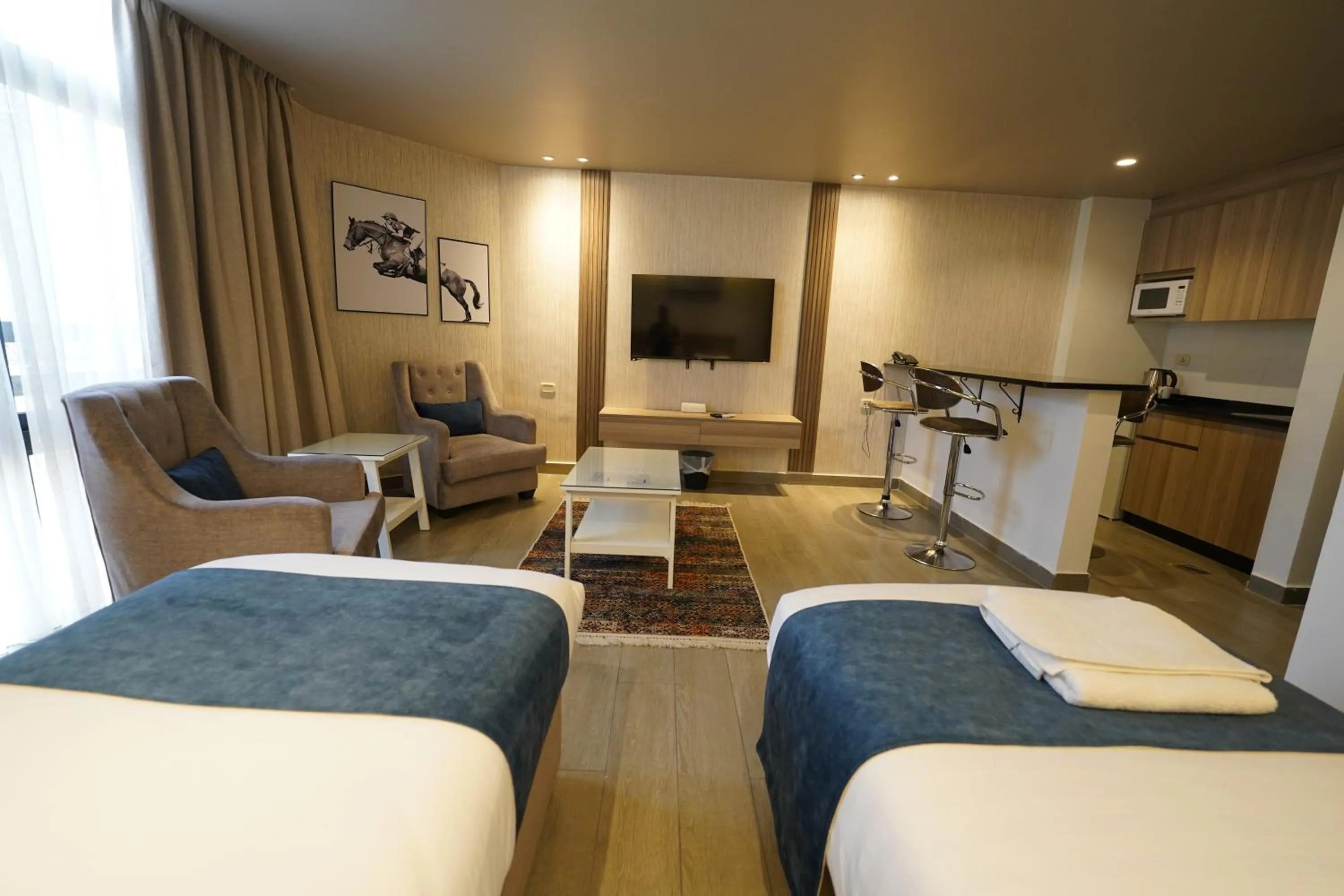 Seating area, Bed in Red Carpet Hotel & Suites