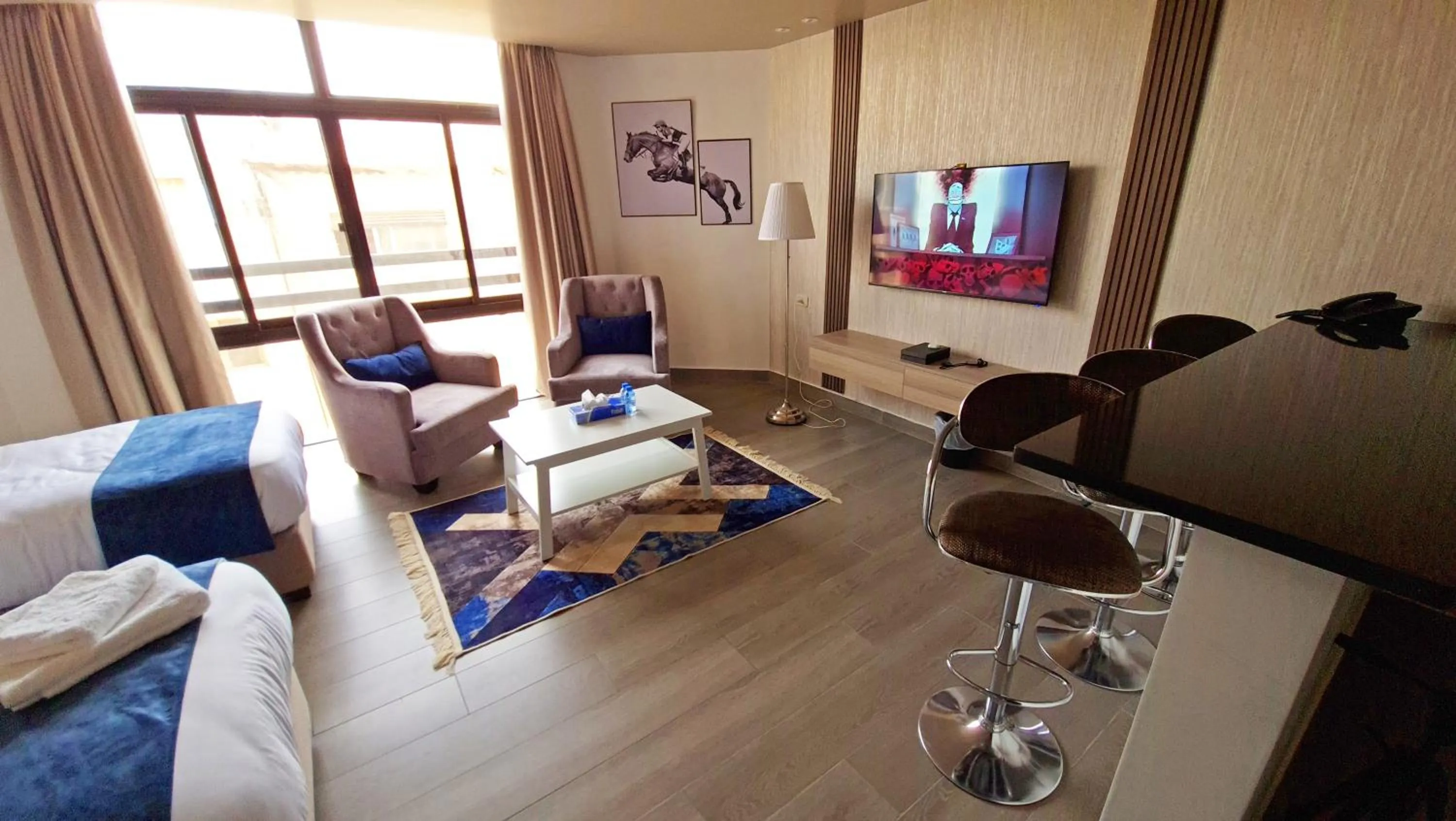 Communal lounge/ TV room in Red Carpet Hotel & Suites