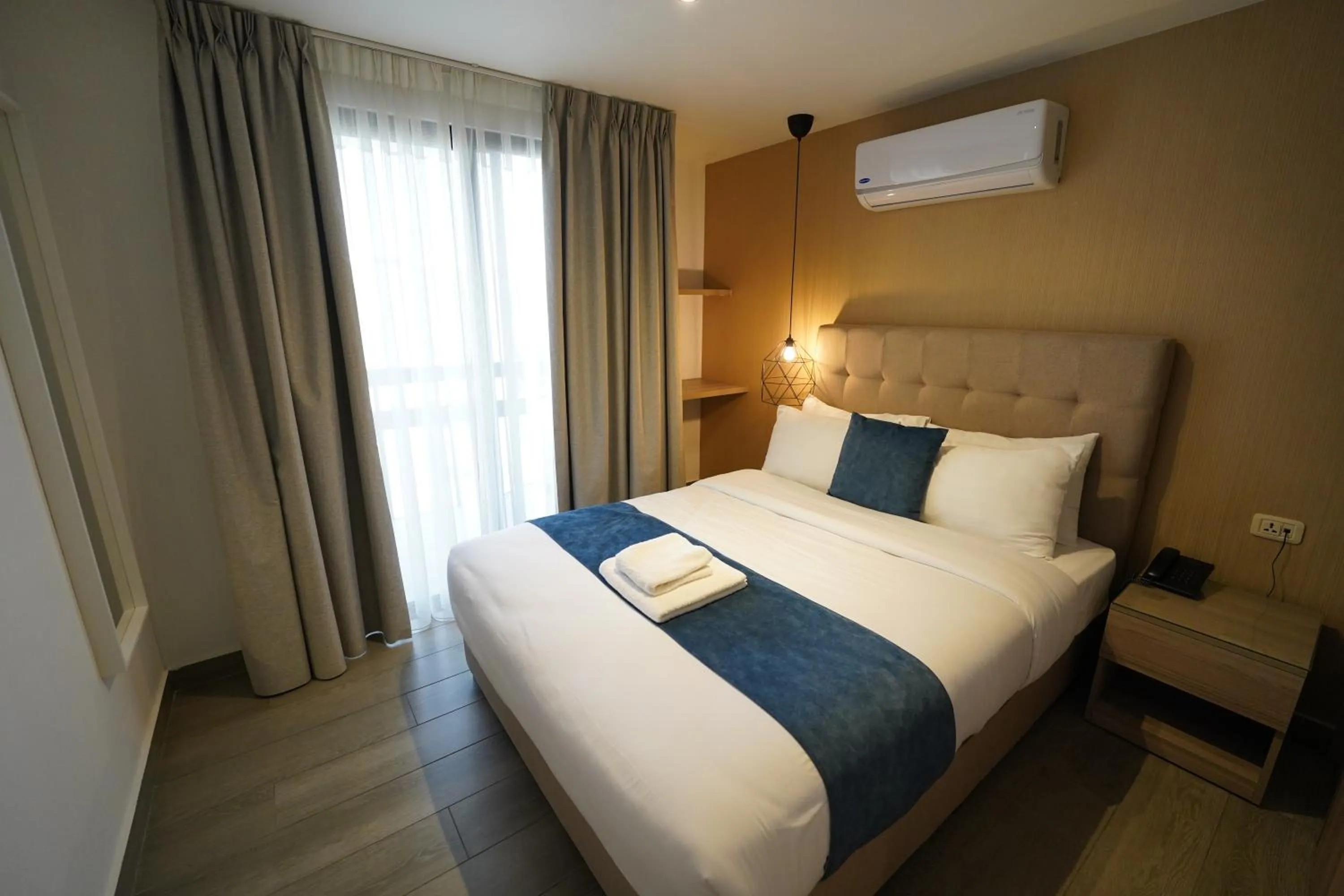 Bed in Red Carpet Hotel & Suites