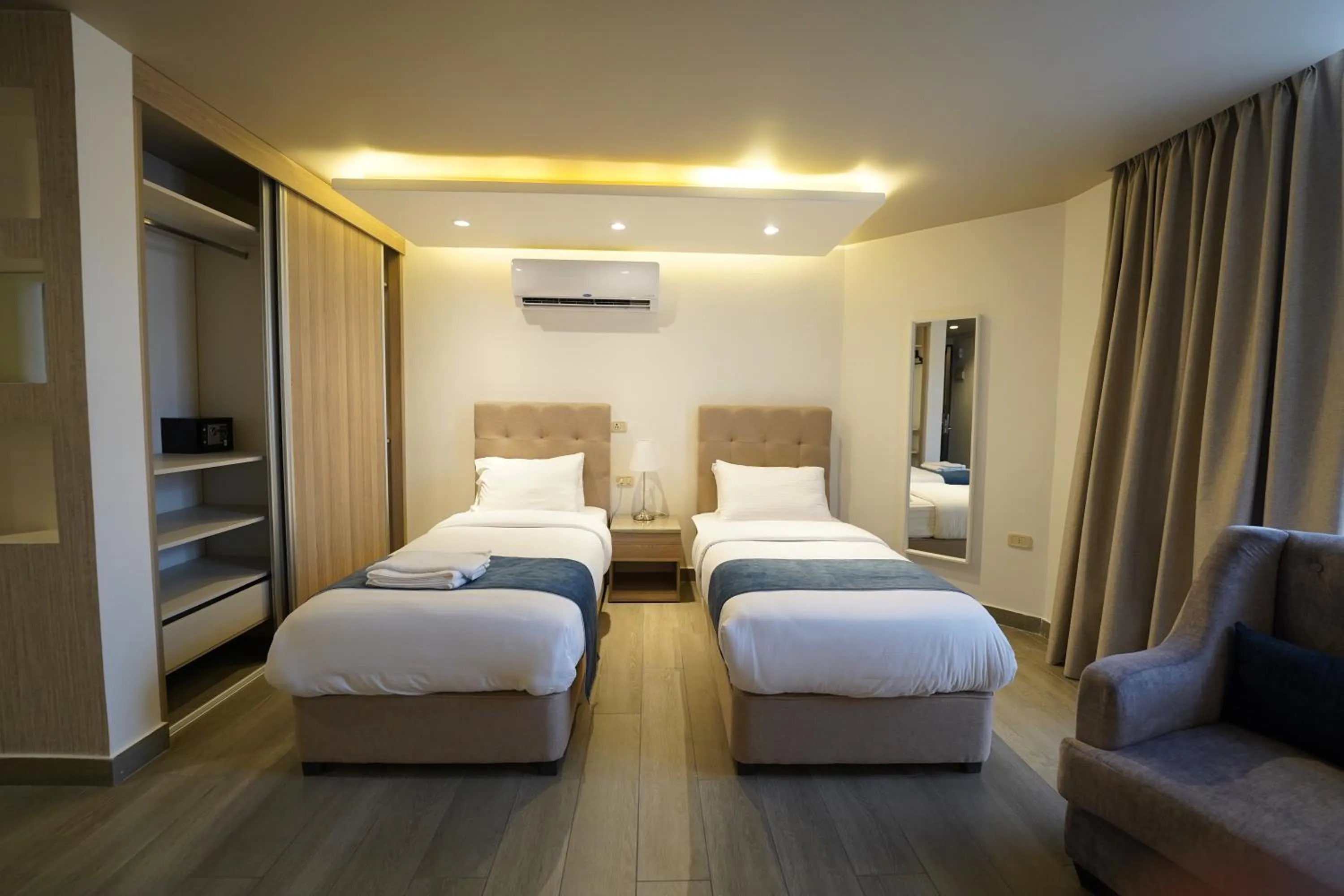 Bed in Red Carpet Hotel & Suites