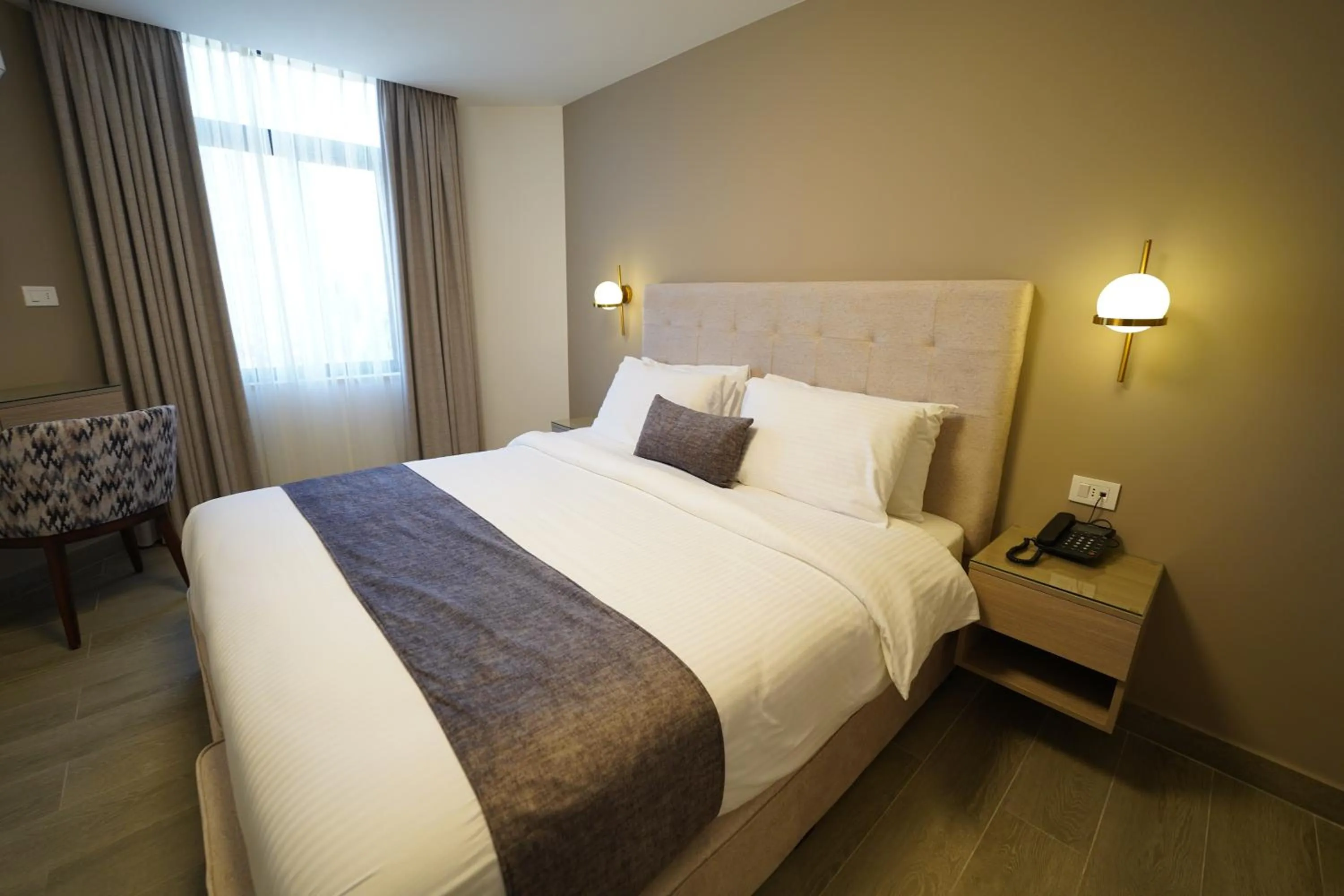 Bed in Red Carpet Hotel & Suites