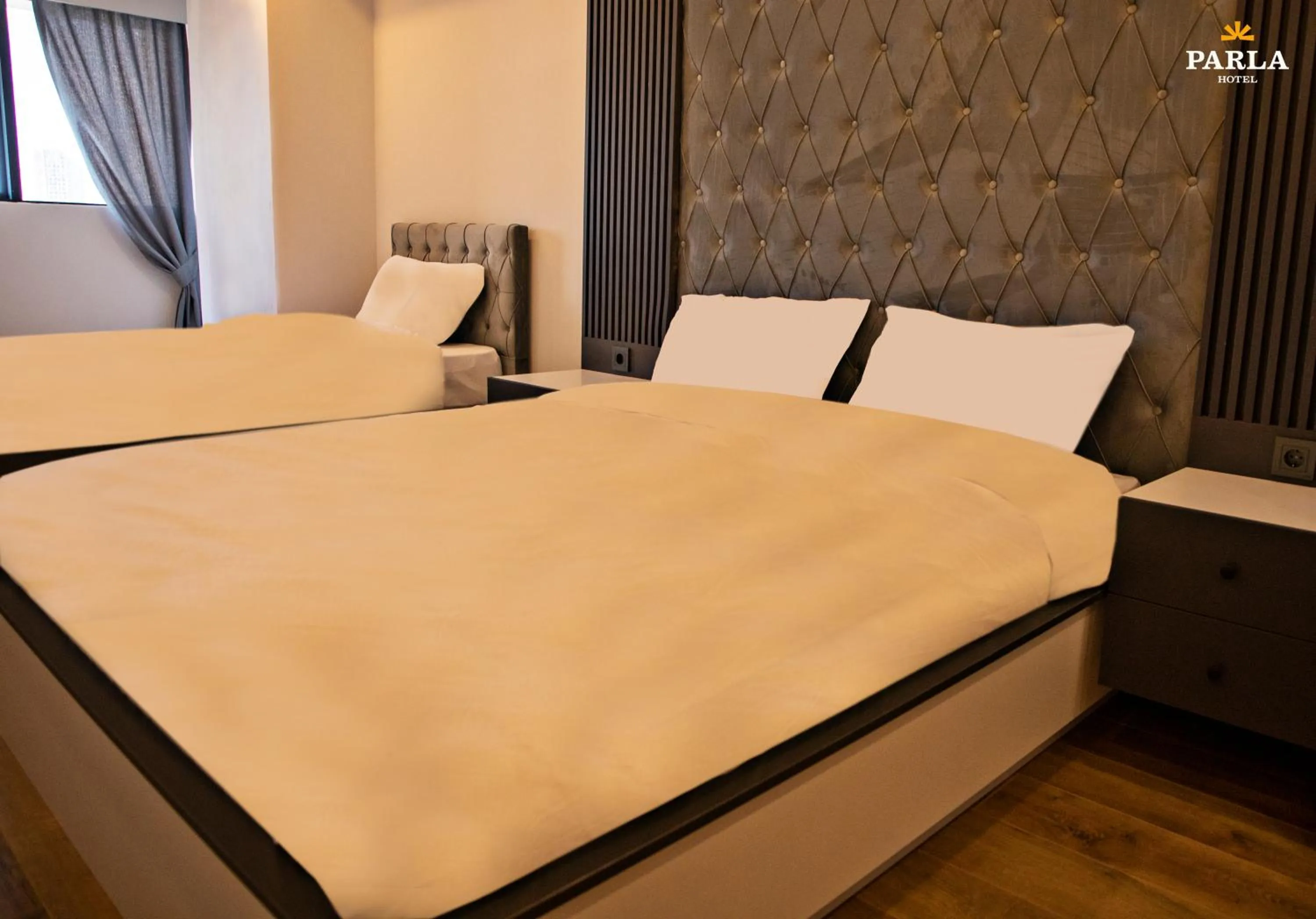 Bed in Parla Suite Hotel