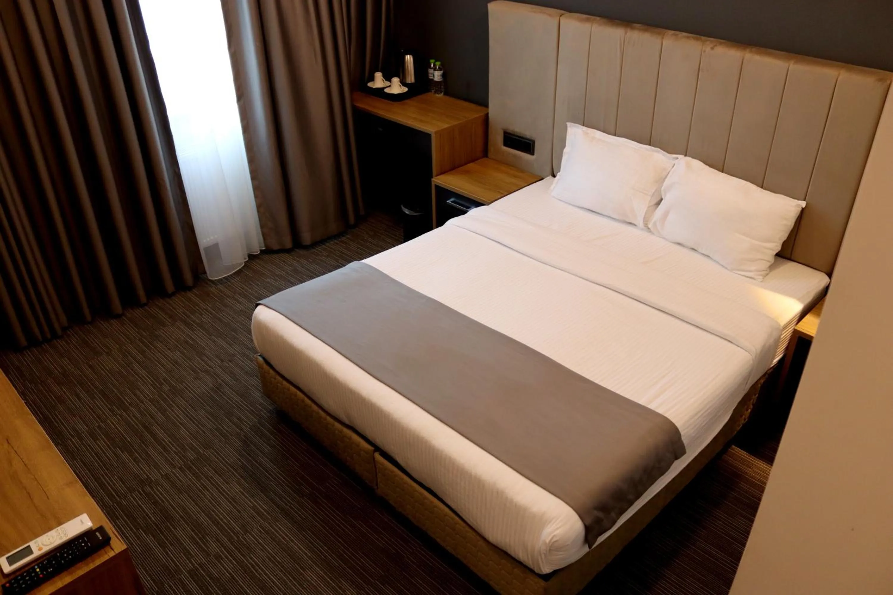 Bed in HOME PLUS Hotel