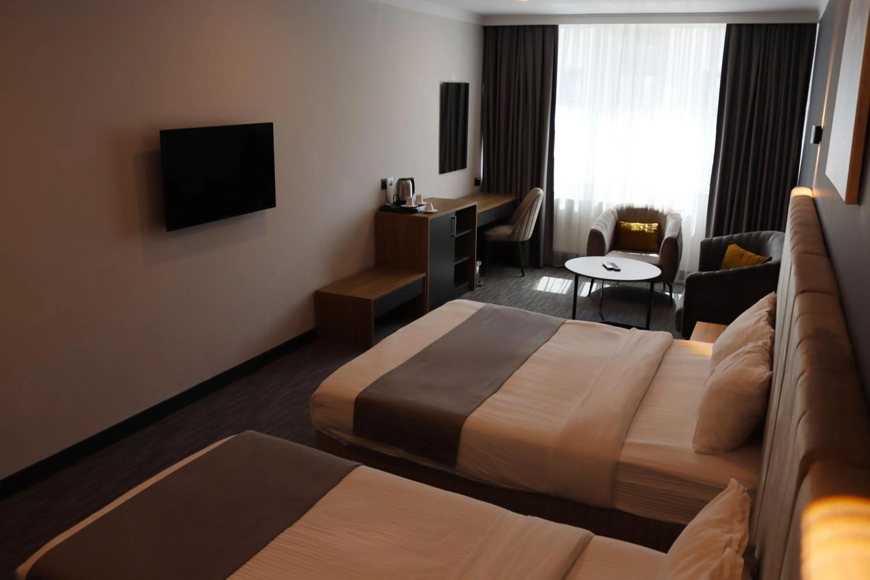 Seating area, Bed in HOME PLUS Hotel