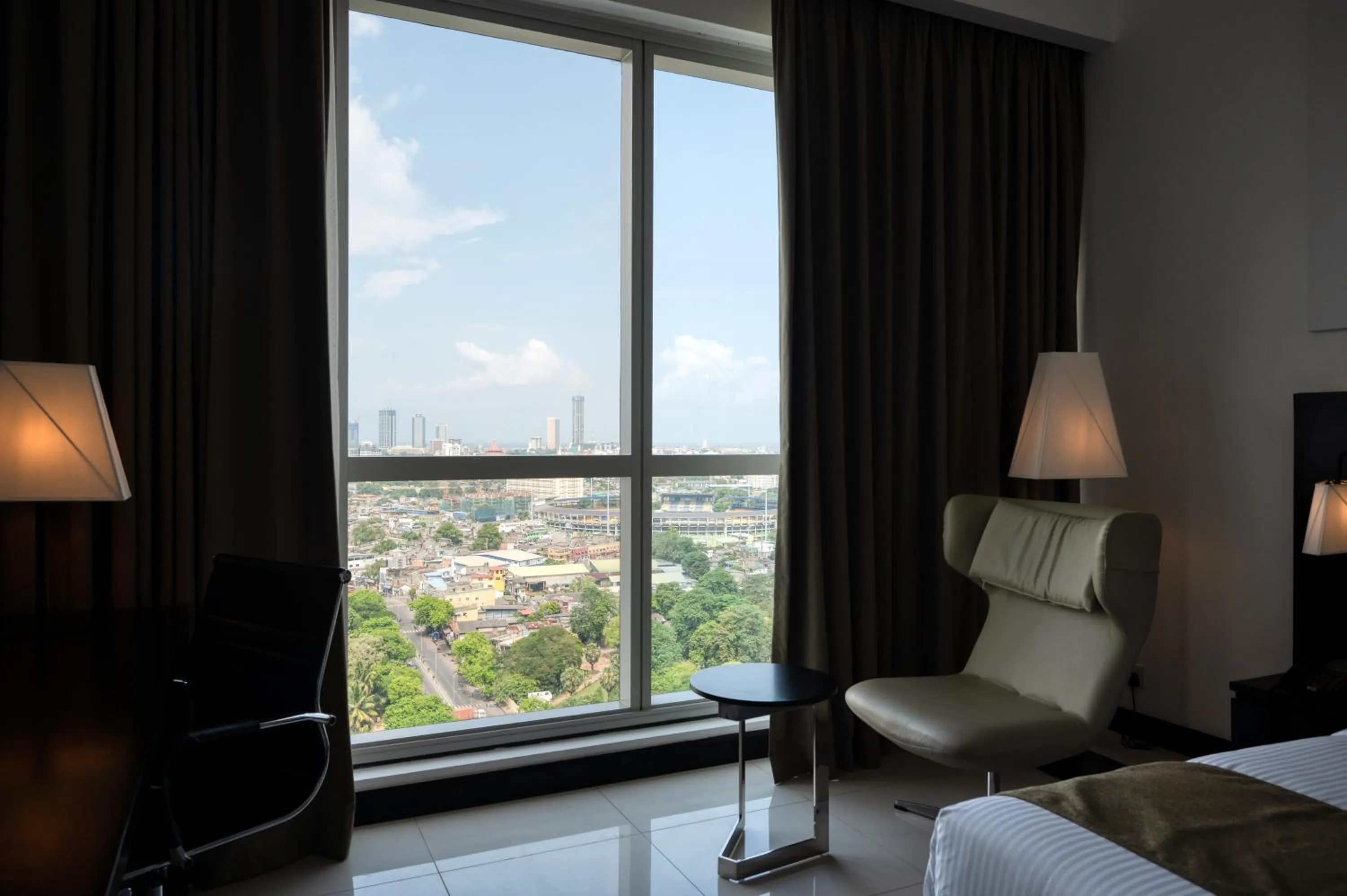 Seating area, Bed in Orion City Hotel