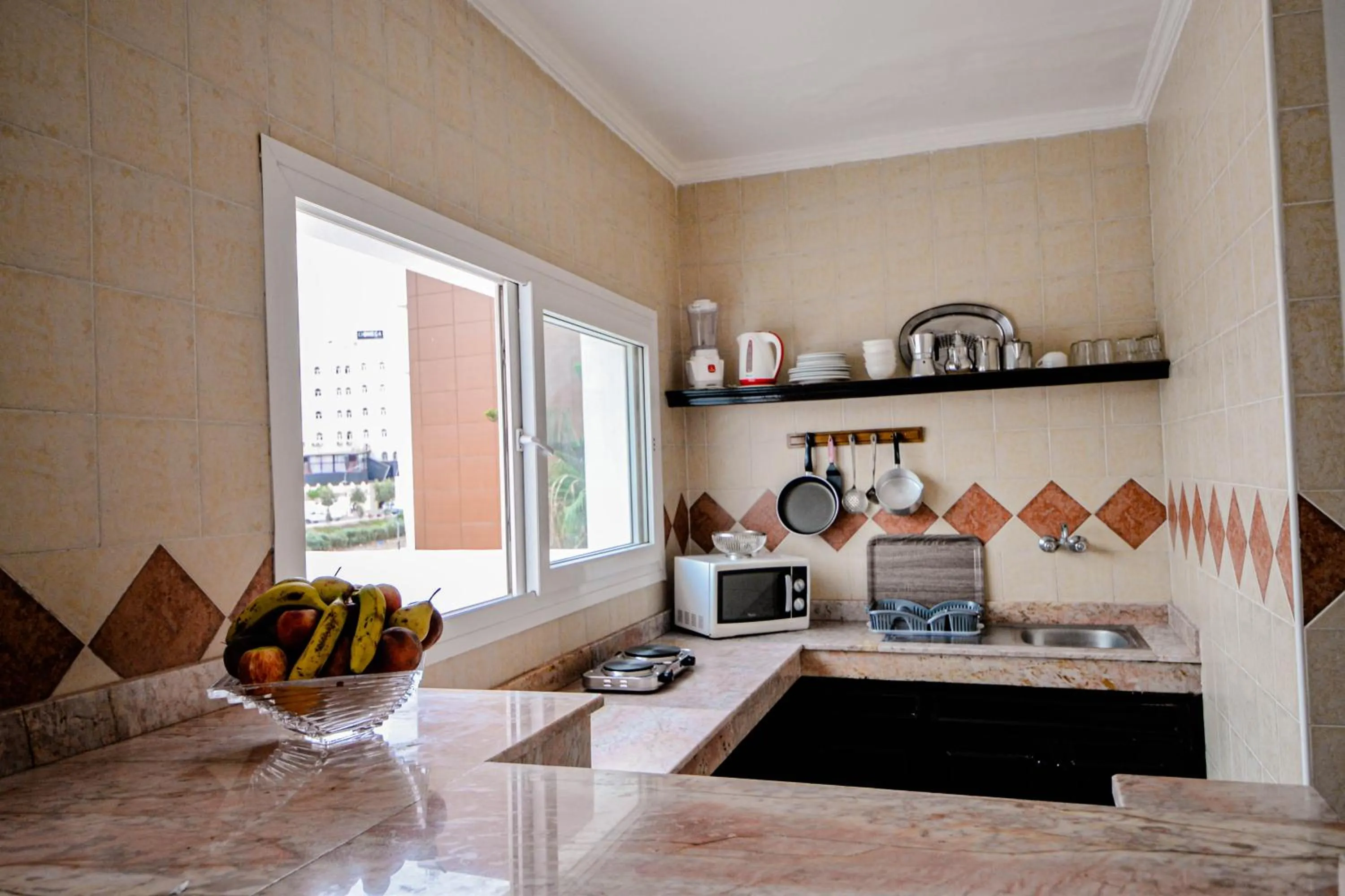 Kitchen or kitchenette in Intouriste Hôtel & Suites