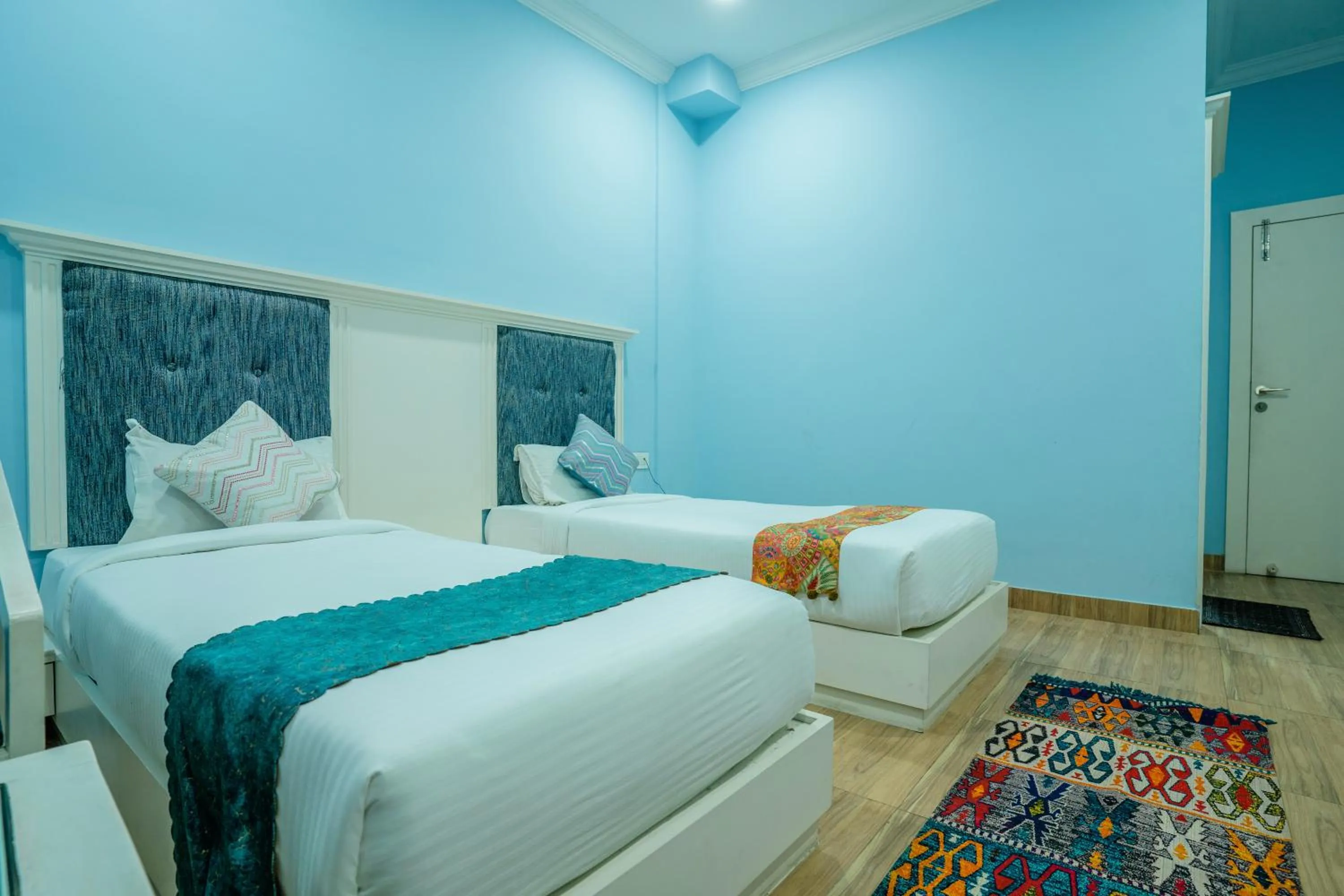 Bed in Tripli Hotels White Manor