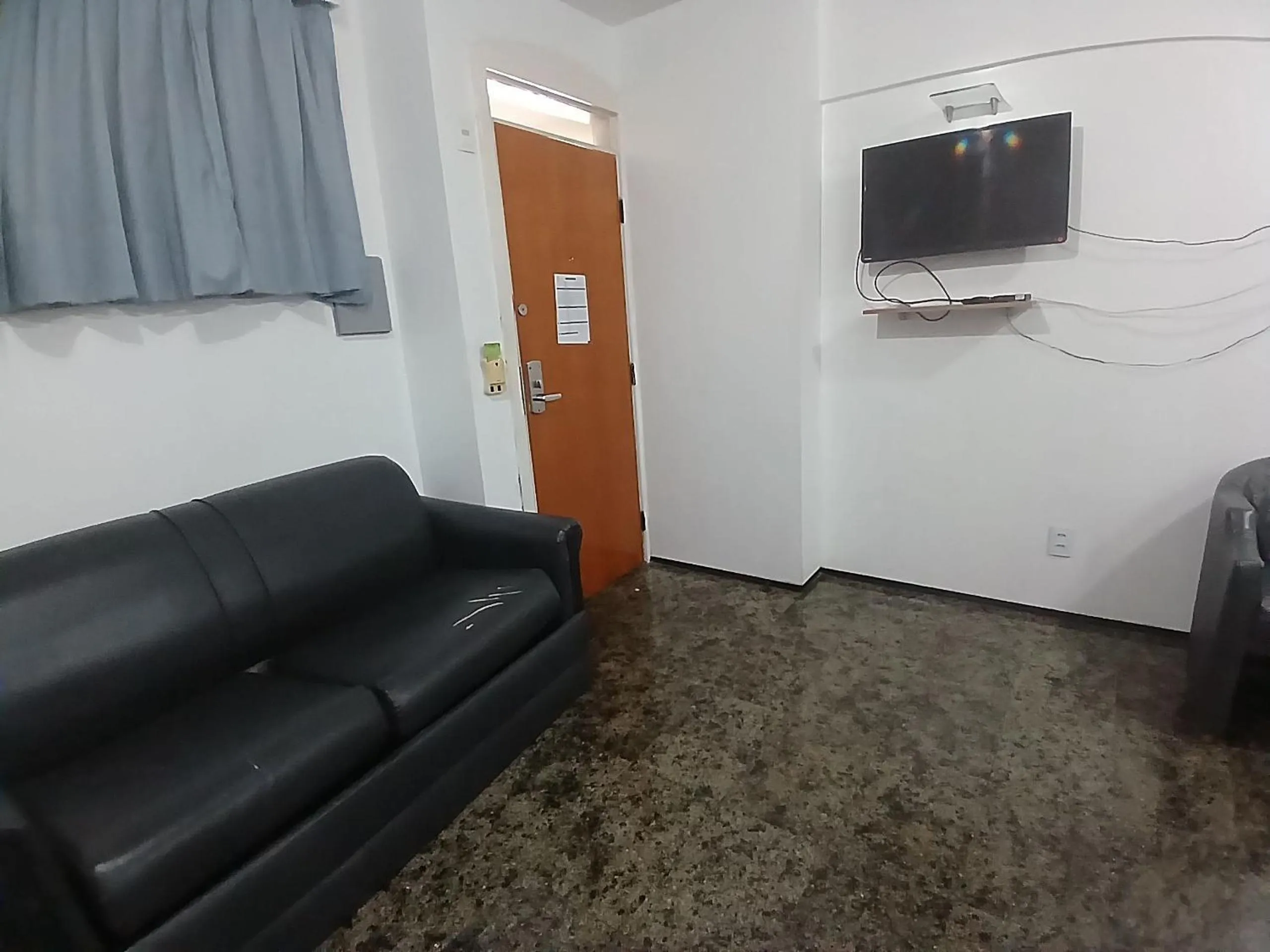 Living room in Flat Brasil Tropical Meireles by Escala