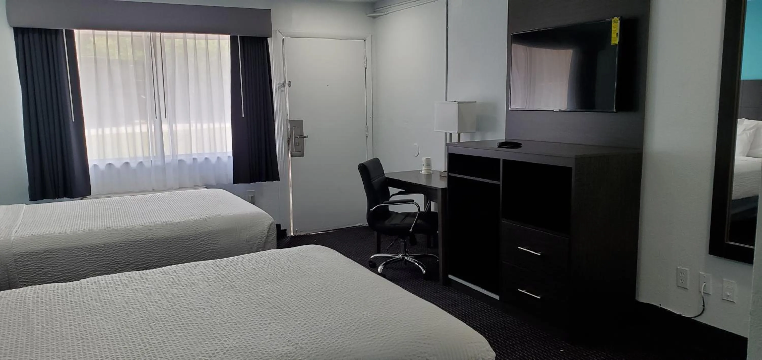 Bedroom, Bed in Travelodge by Wyndham Livonia Canton Novi Detroit Area