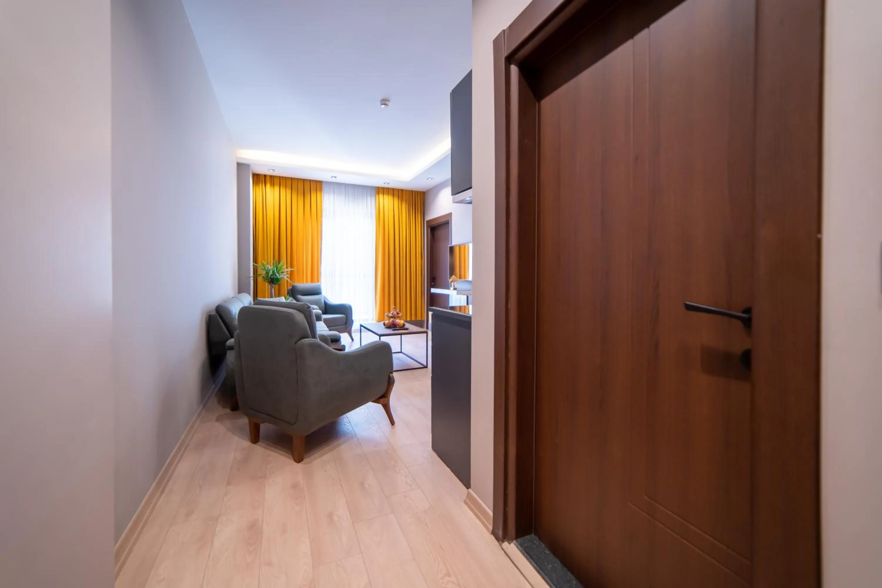 Seating area, Bed in Garden Room Suit Hotel