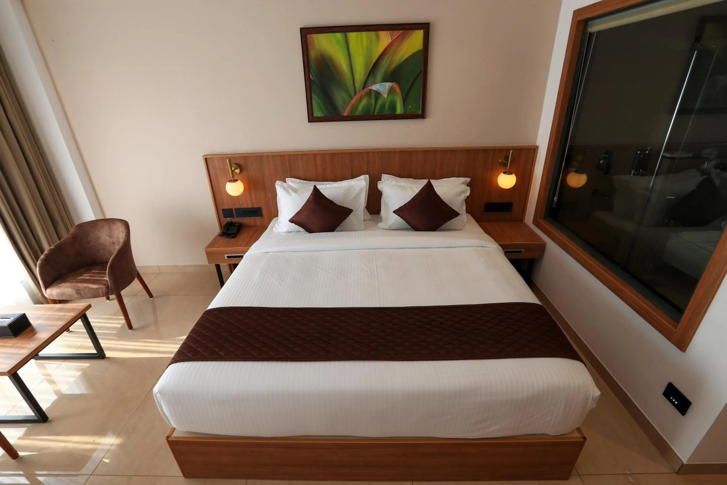 Bed in Hotel Saffron Wayanad