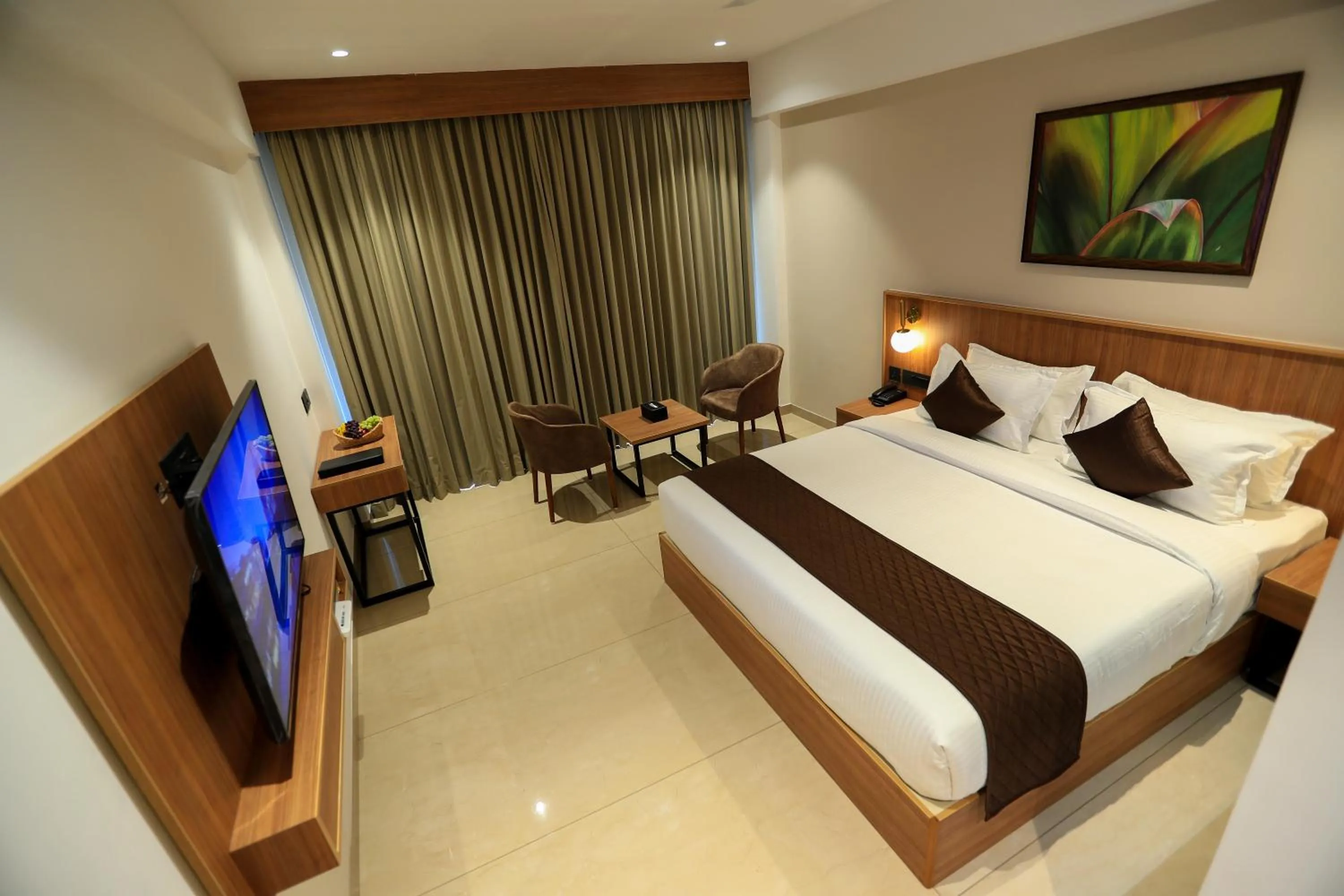 Bed in Hotel Saffron Wayanad