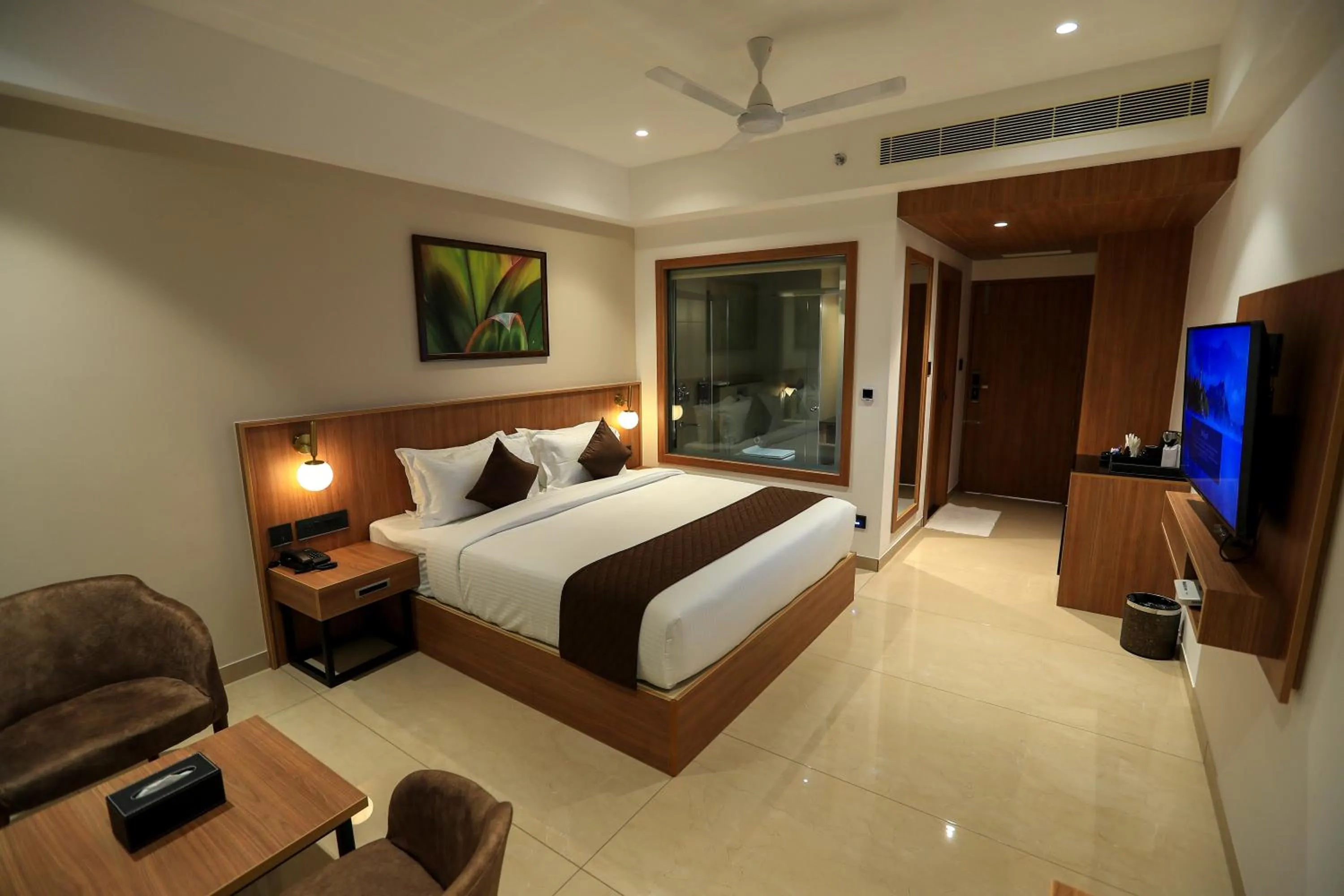 Communal lounge/ TV room, Bed in Hotel Saffron Wayanad