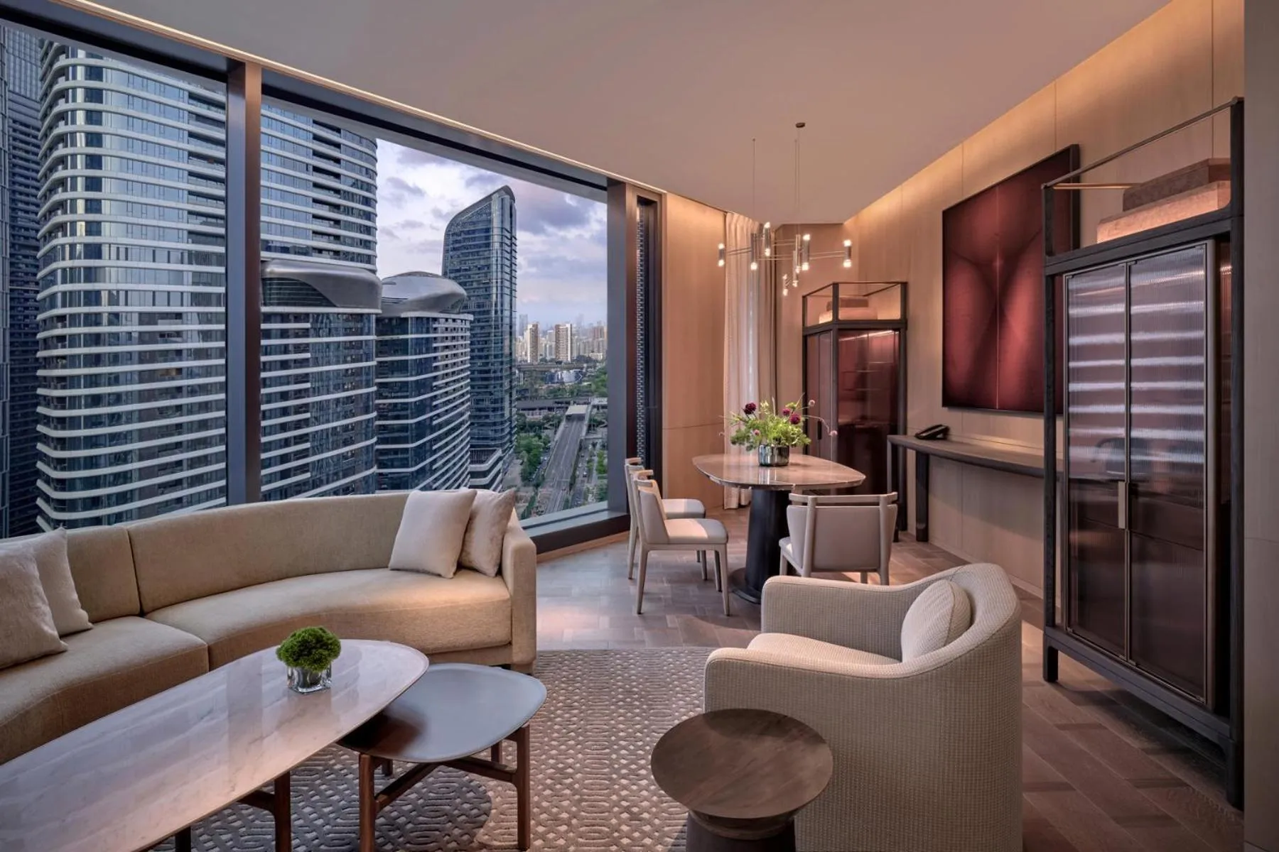 Living room in Conrad Shenzhen, the first art museum hotel in Greater Bay Area with the stunning bay and sunset view in the hotel terrace