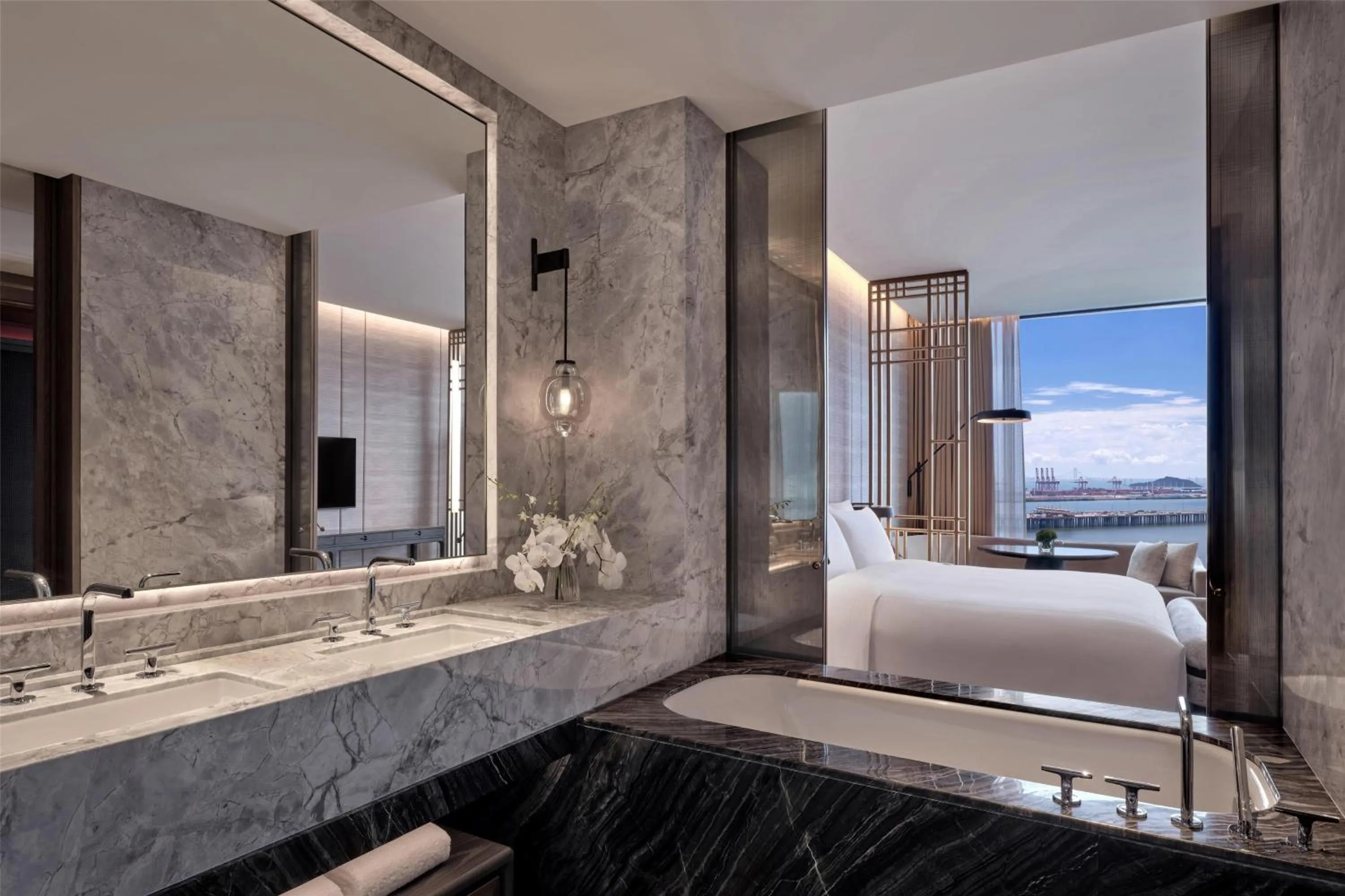 Bed in Conrad Shenzhen, the first art museum hotel in Greater Bay Area with the stunning bay and sunset view in the hotel terrace