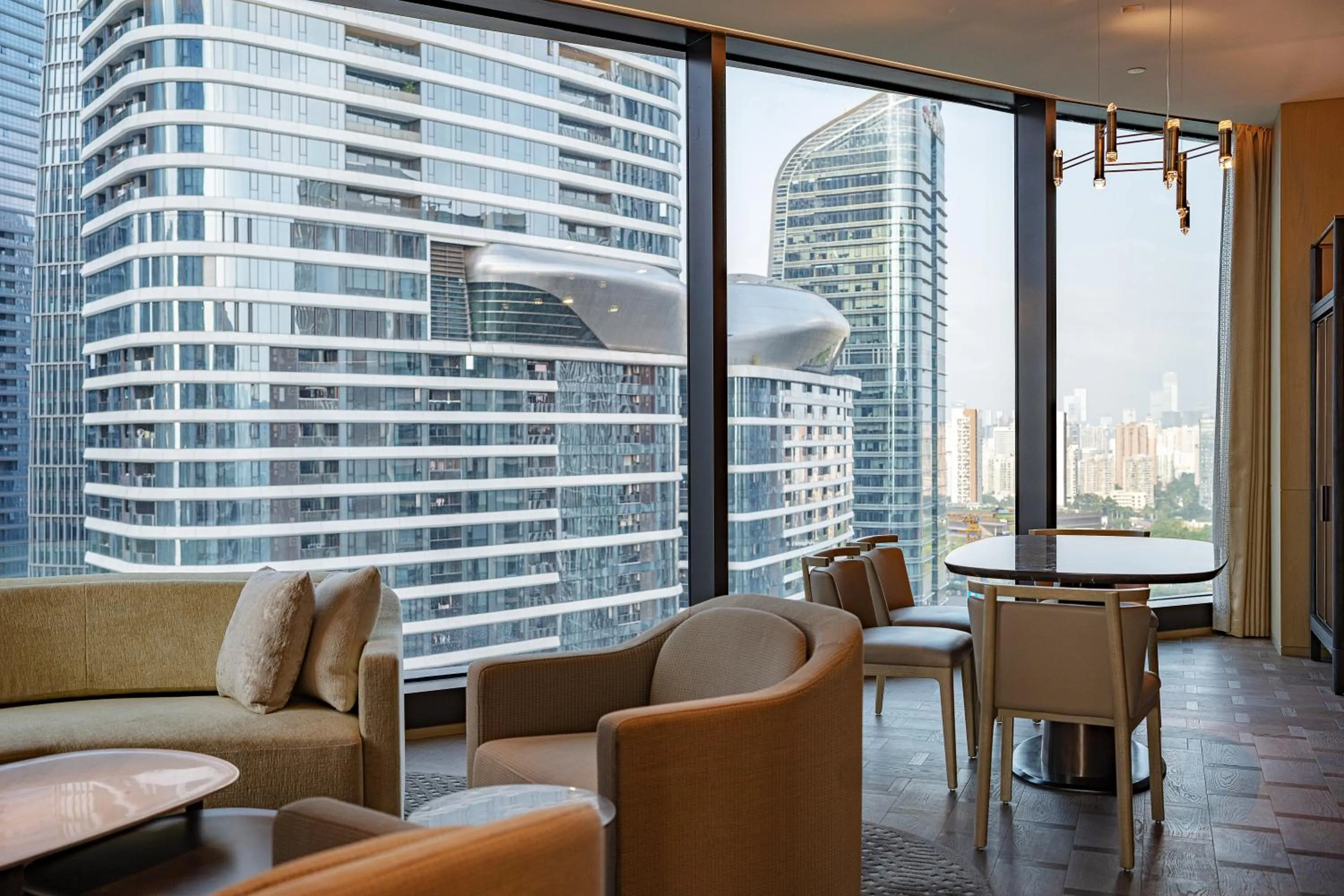 Seating area in Conrad Shenzhen, the first art museum hotel in Greater Bay Area with the stunning bay and sunset view in the hotel terrace