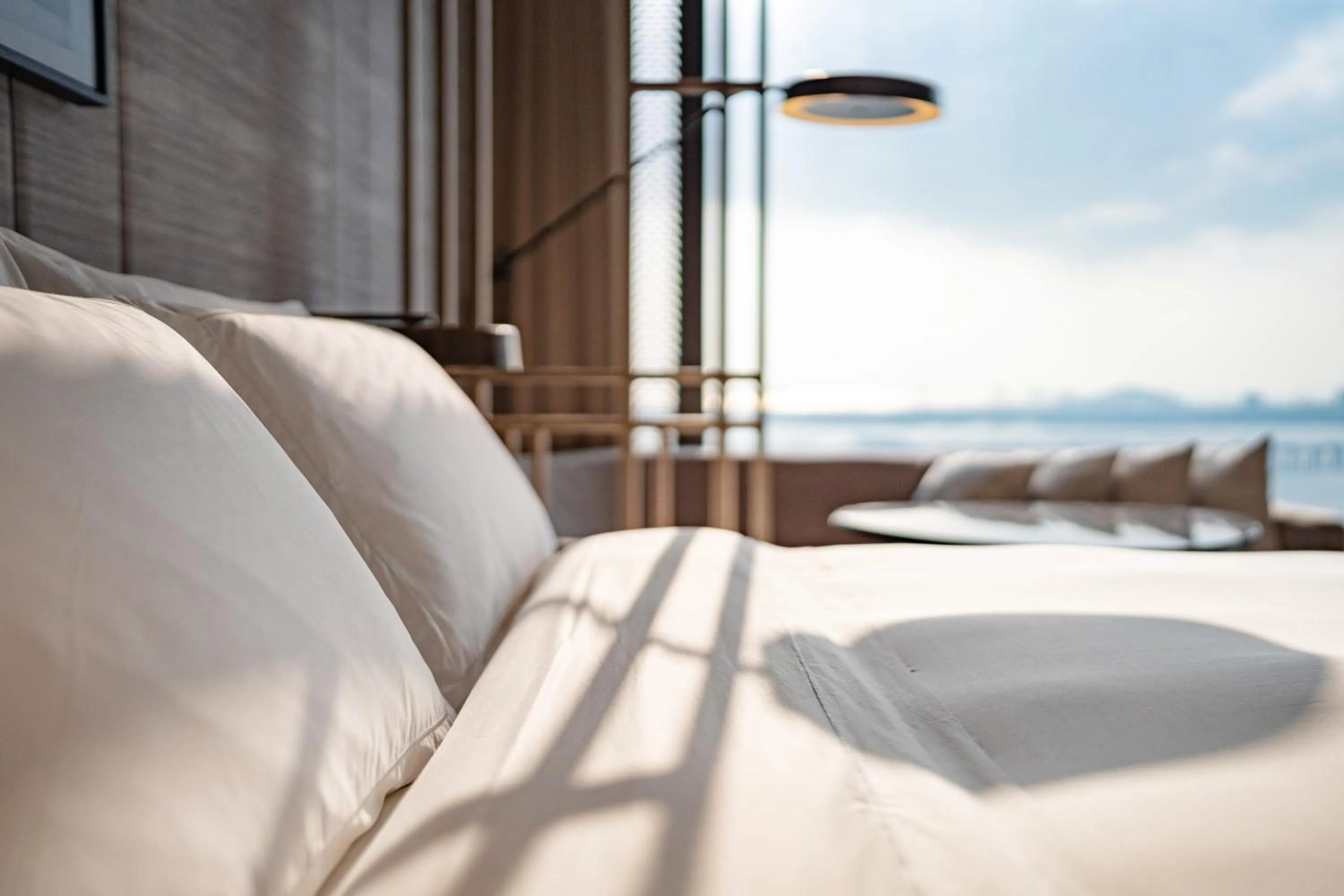 Seating area, Bed in Conrad Shenzhen, the first art museum hotel in Greater Bay Area with the stunning bay and sunset view in the hotel terrace