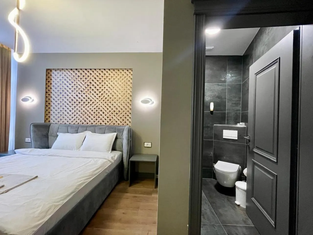Bed in GRAND JNK Boutique Hotel