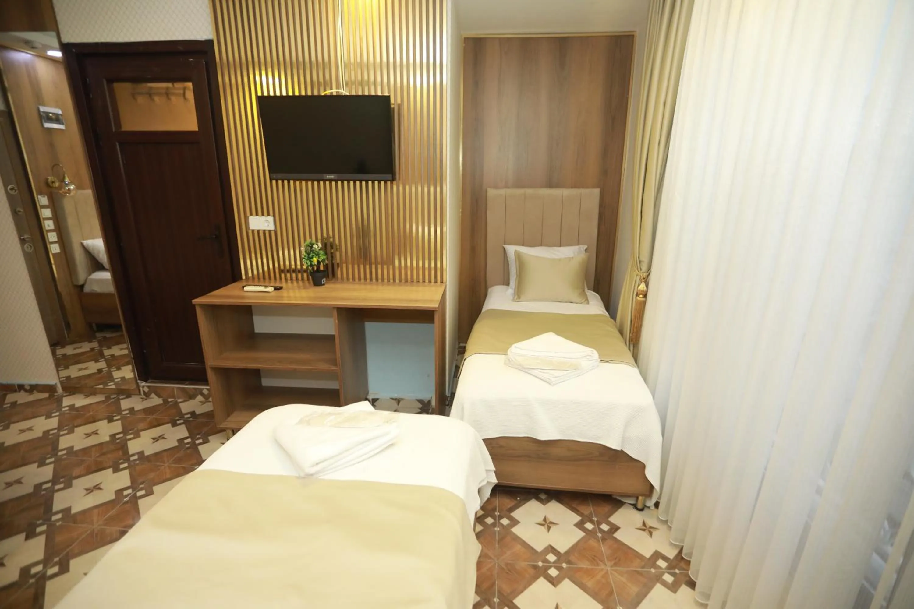 Bed in IMMORTELLE HOTEL