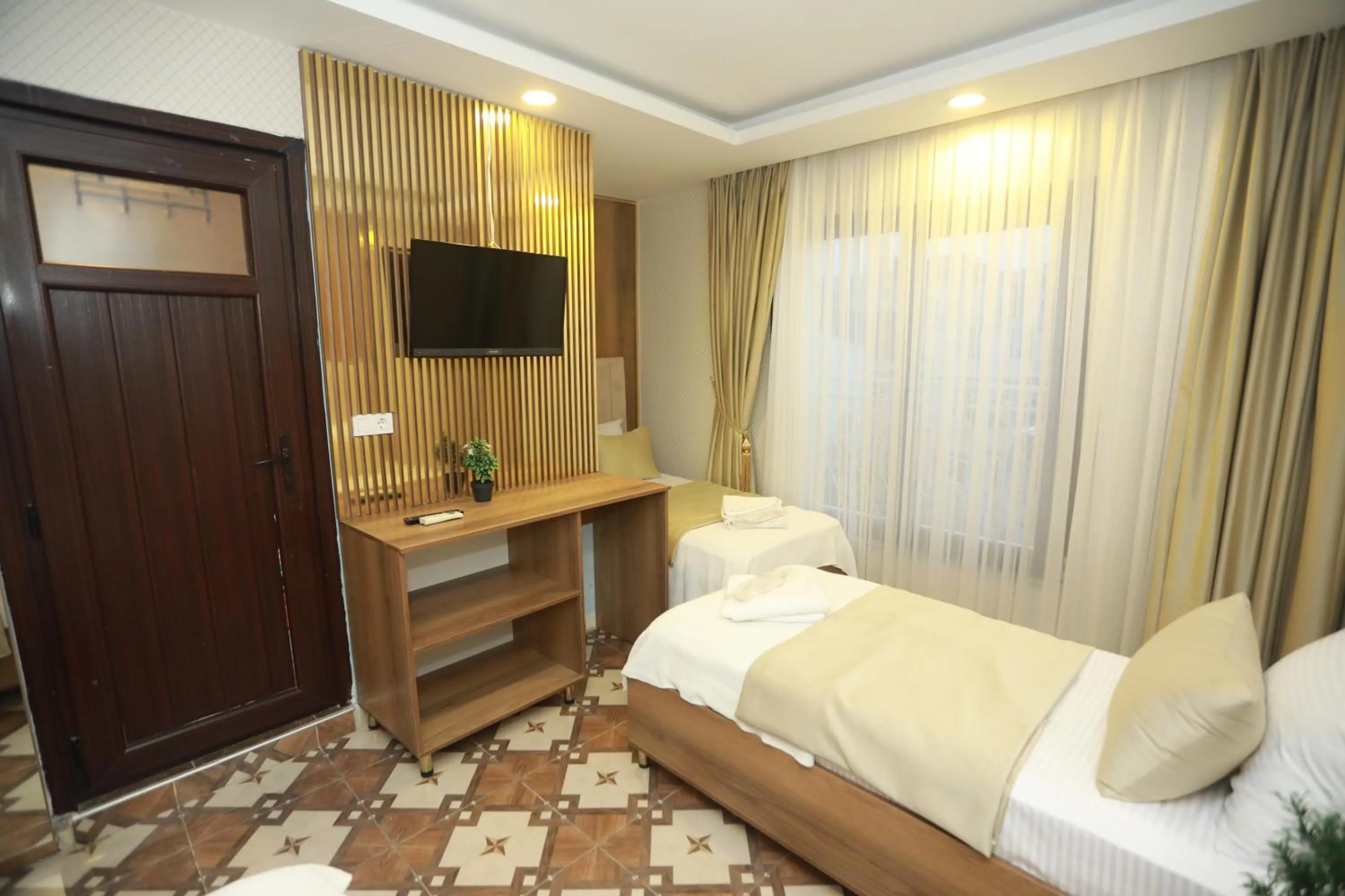 Bed in IMMORTELLE HOTEL