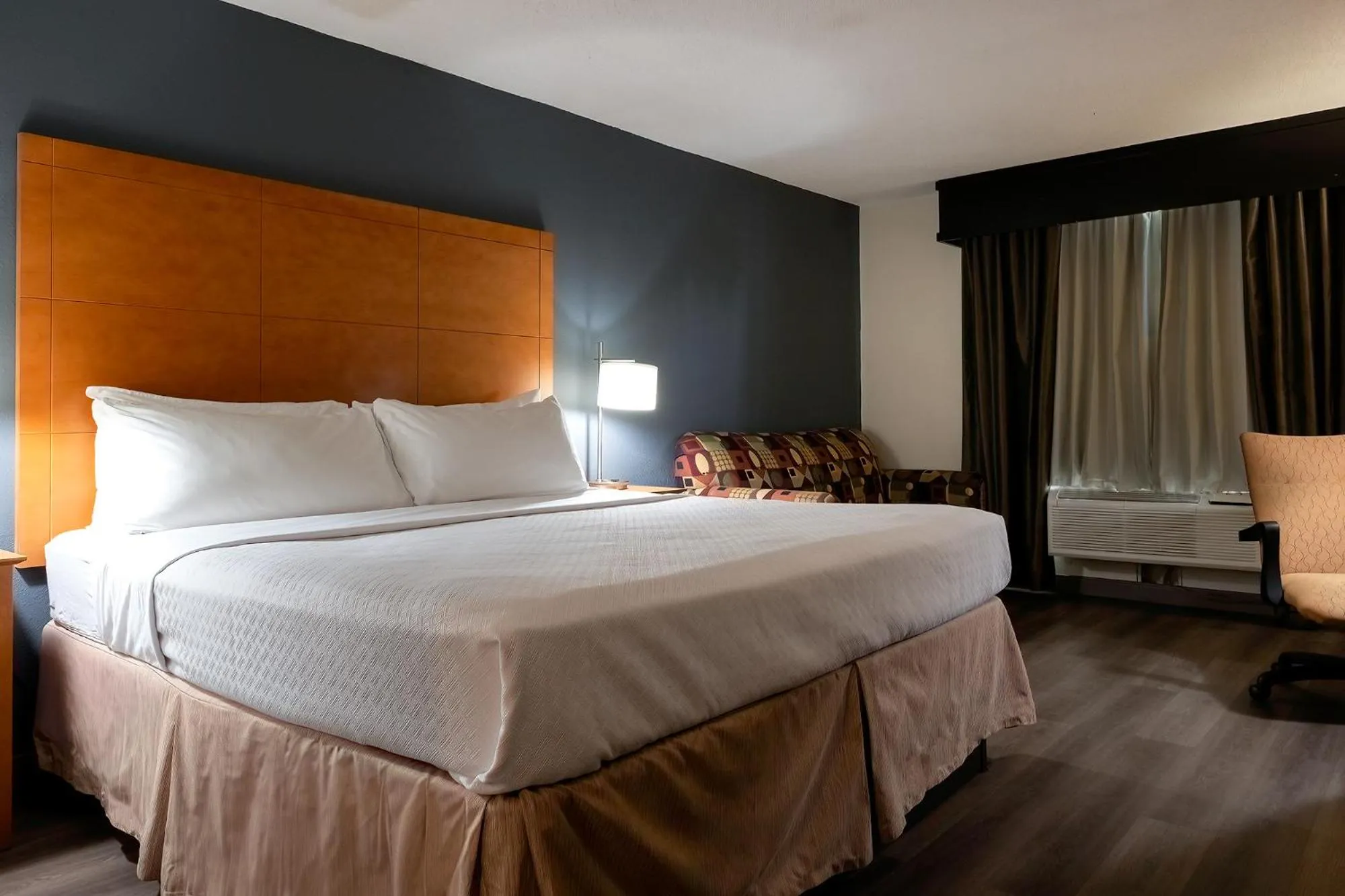 Bed in American Inn & Suites