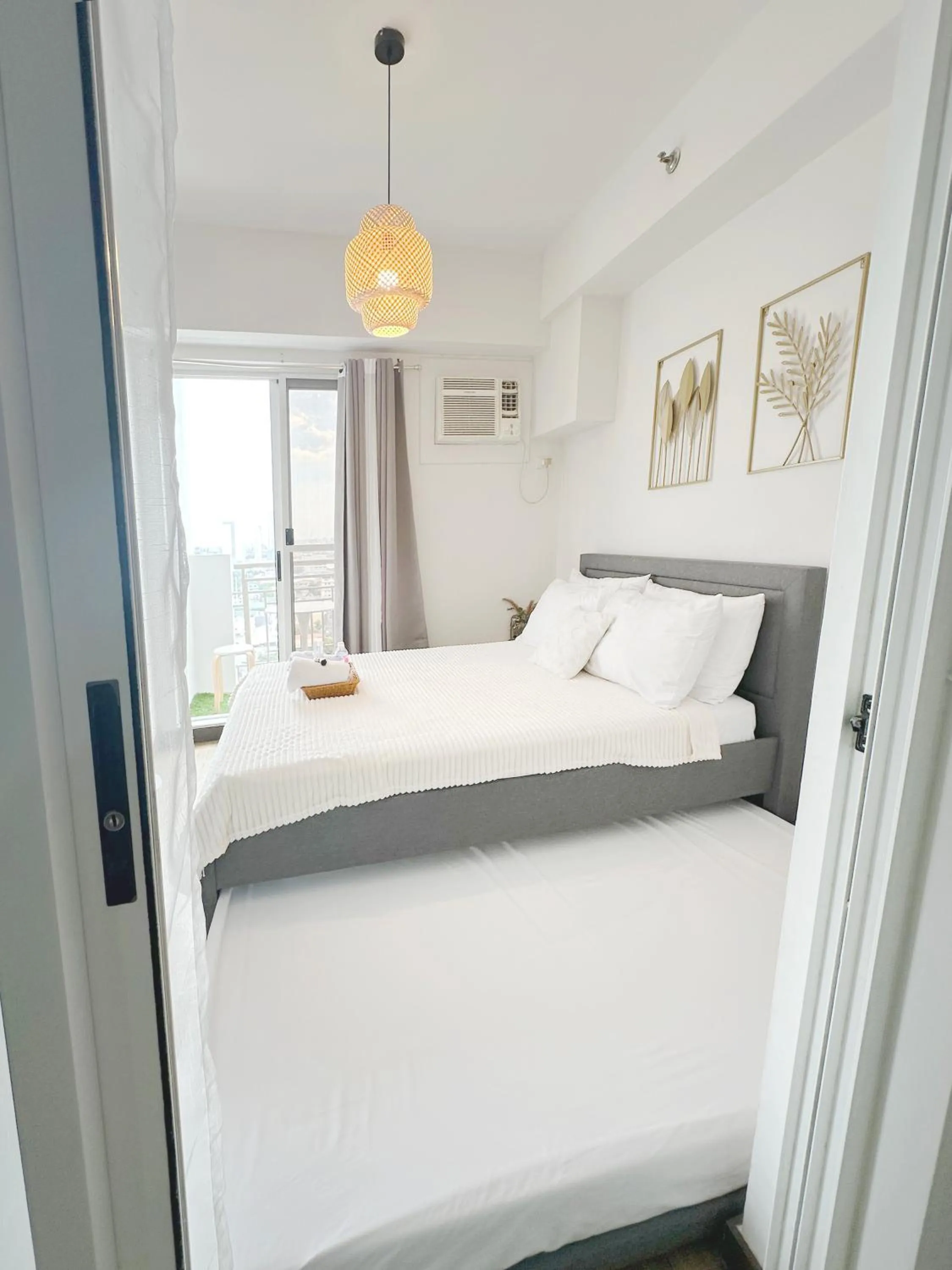 Bed in Zinnia Towers 1BR Condo with PS4 Karaoke Netflix & Swimming Pool