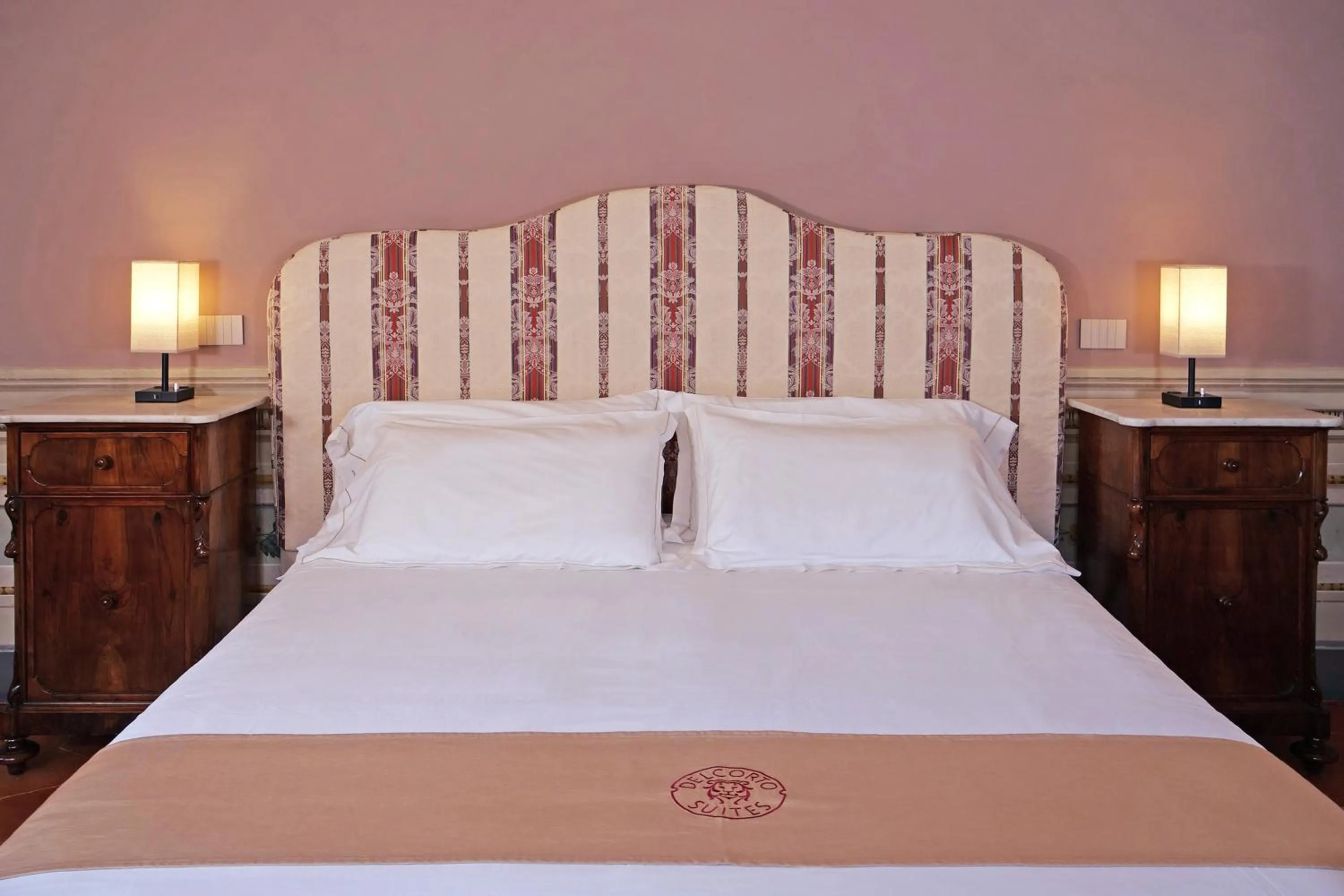 Bed in Delcorto Suites