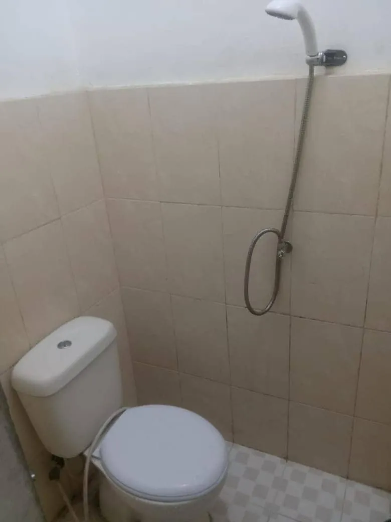 Bathroom in Hotel O Penginapan & Villa Sirait