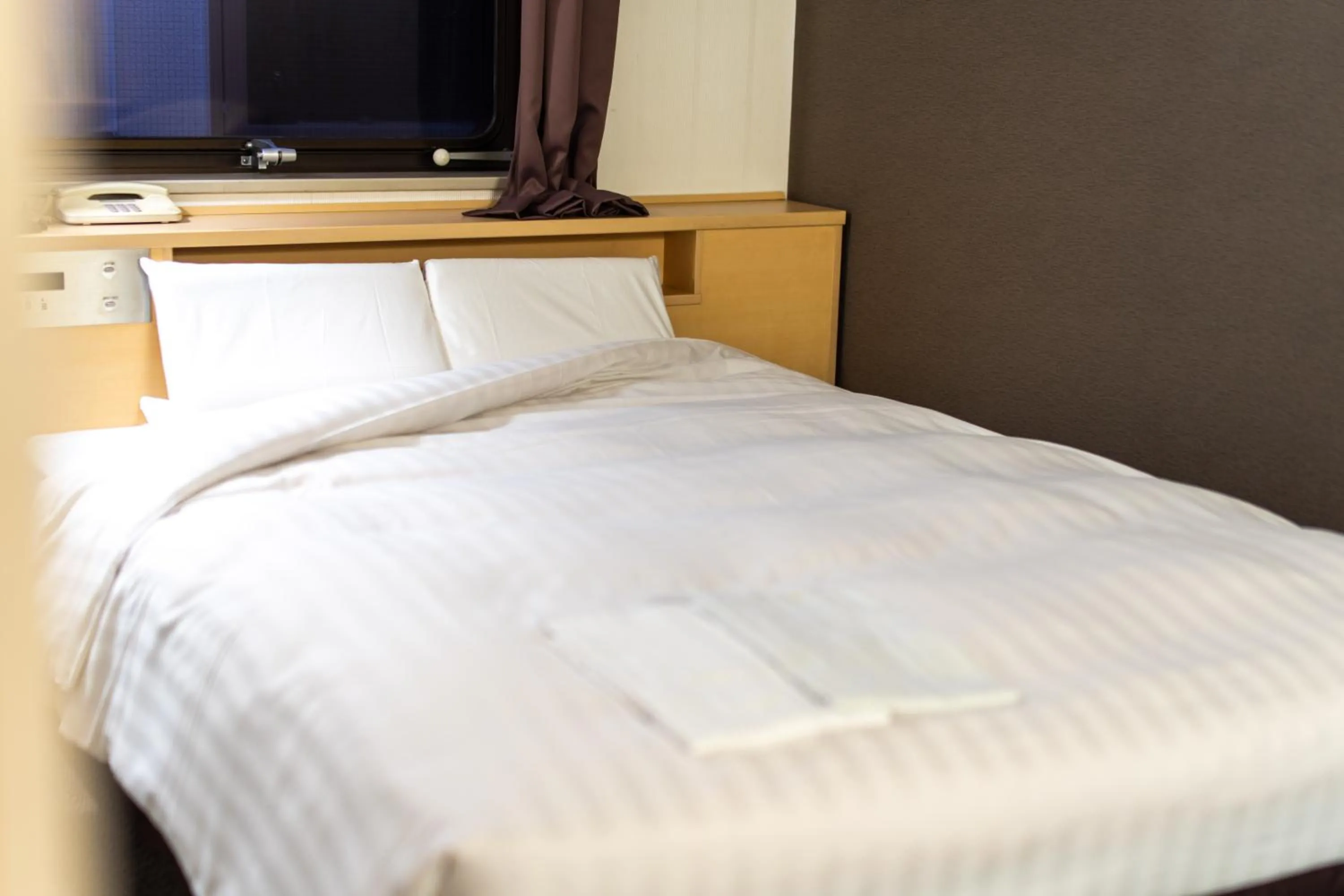 Bed in Ramada Encore by Wyndham Amagasaki