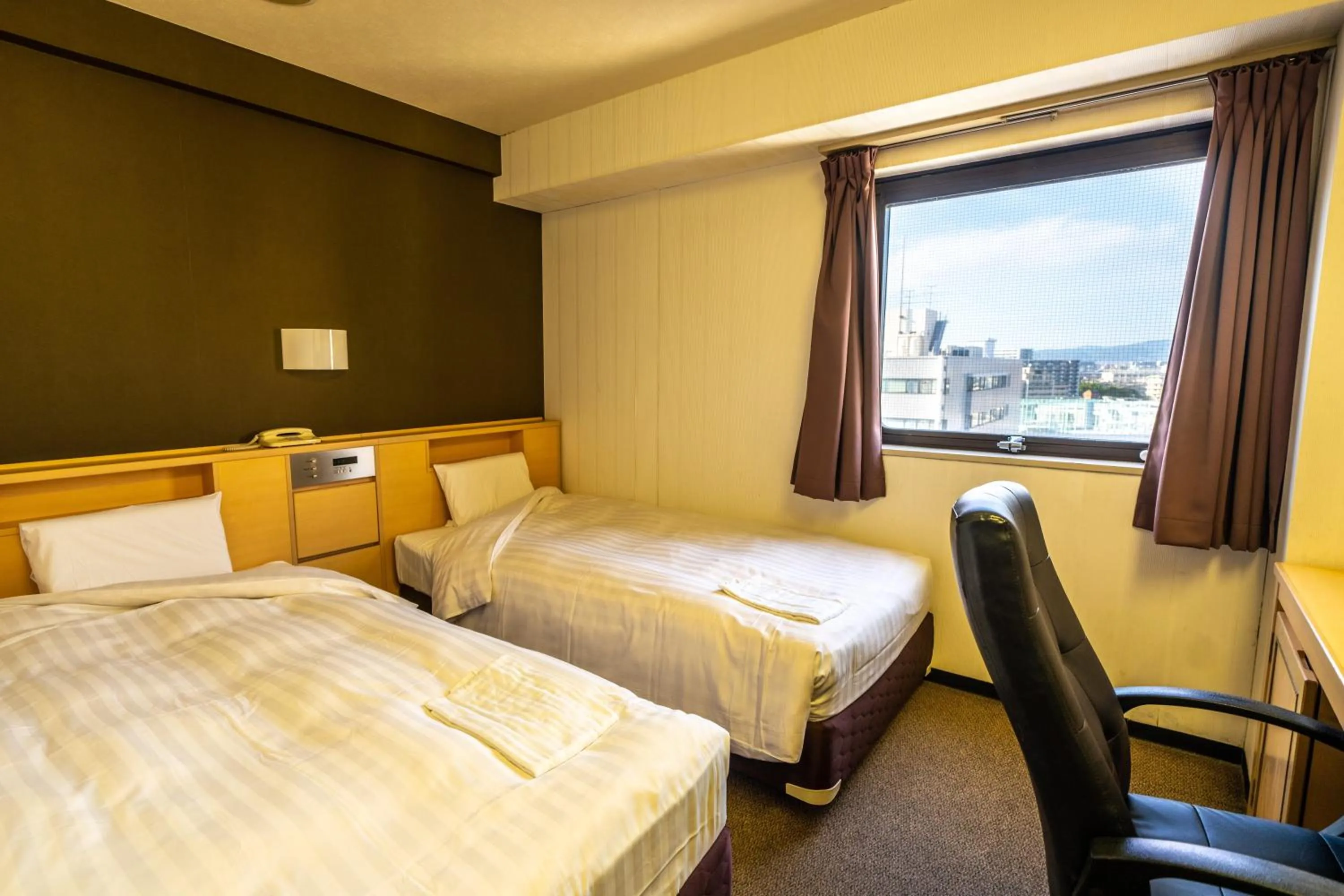 Bed in Ramada Encore by Wyndham Amagasaki