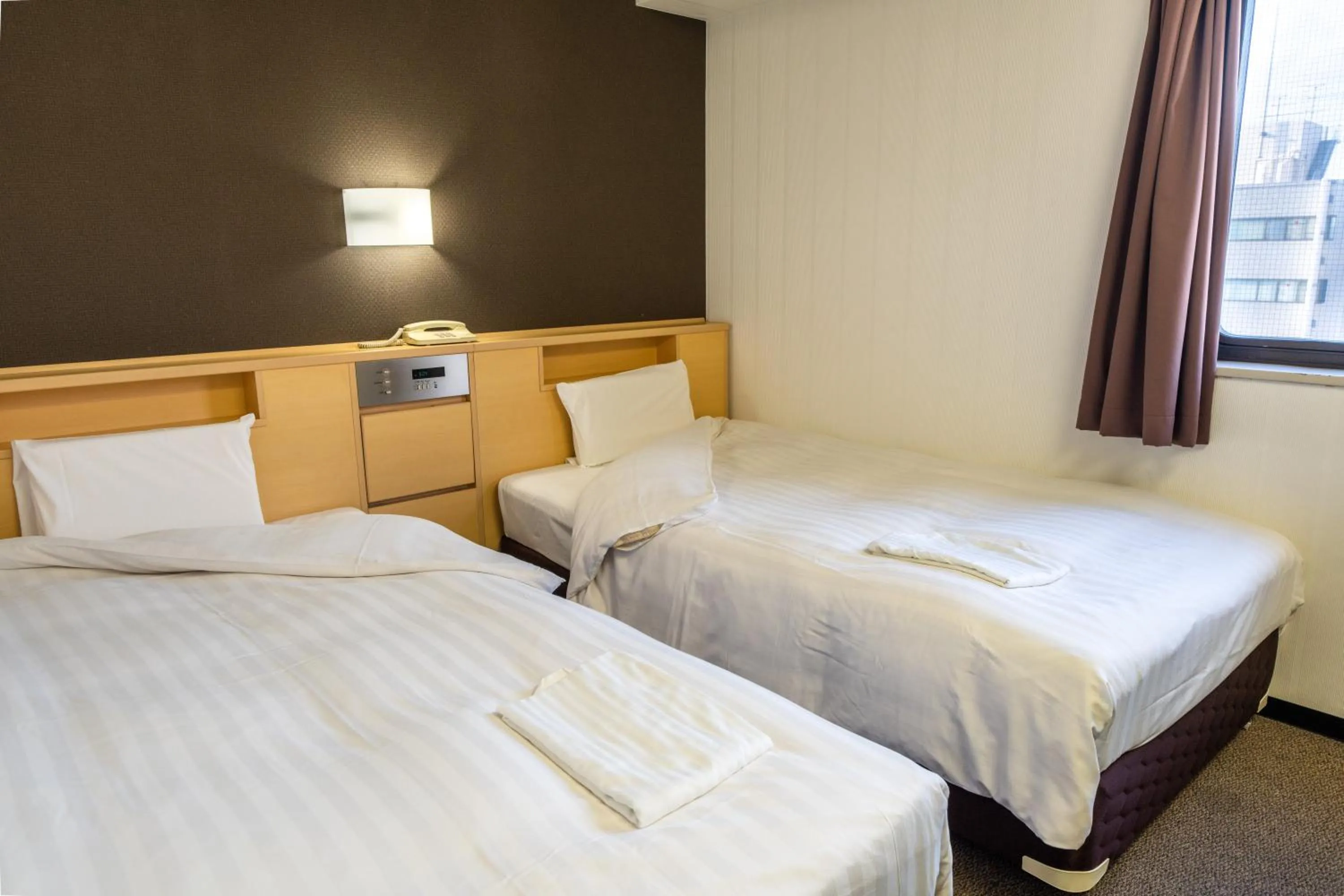 Bed in Ramada Encore by Wyndham Amagasaki