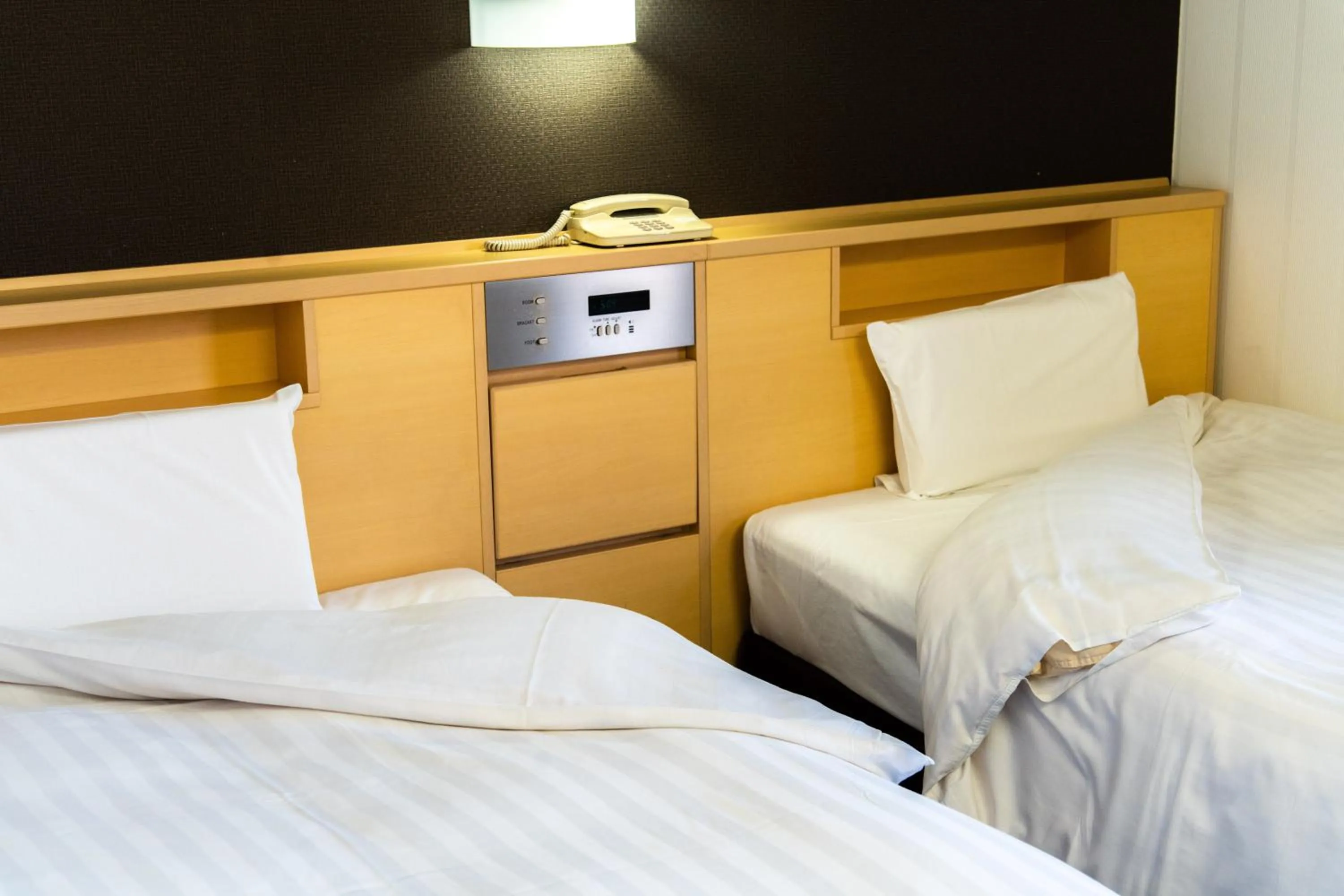 Bed in Ramada Encore by Wyndham Amagasaki