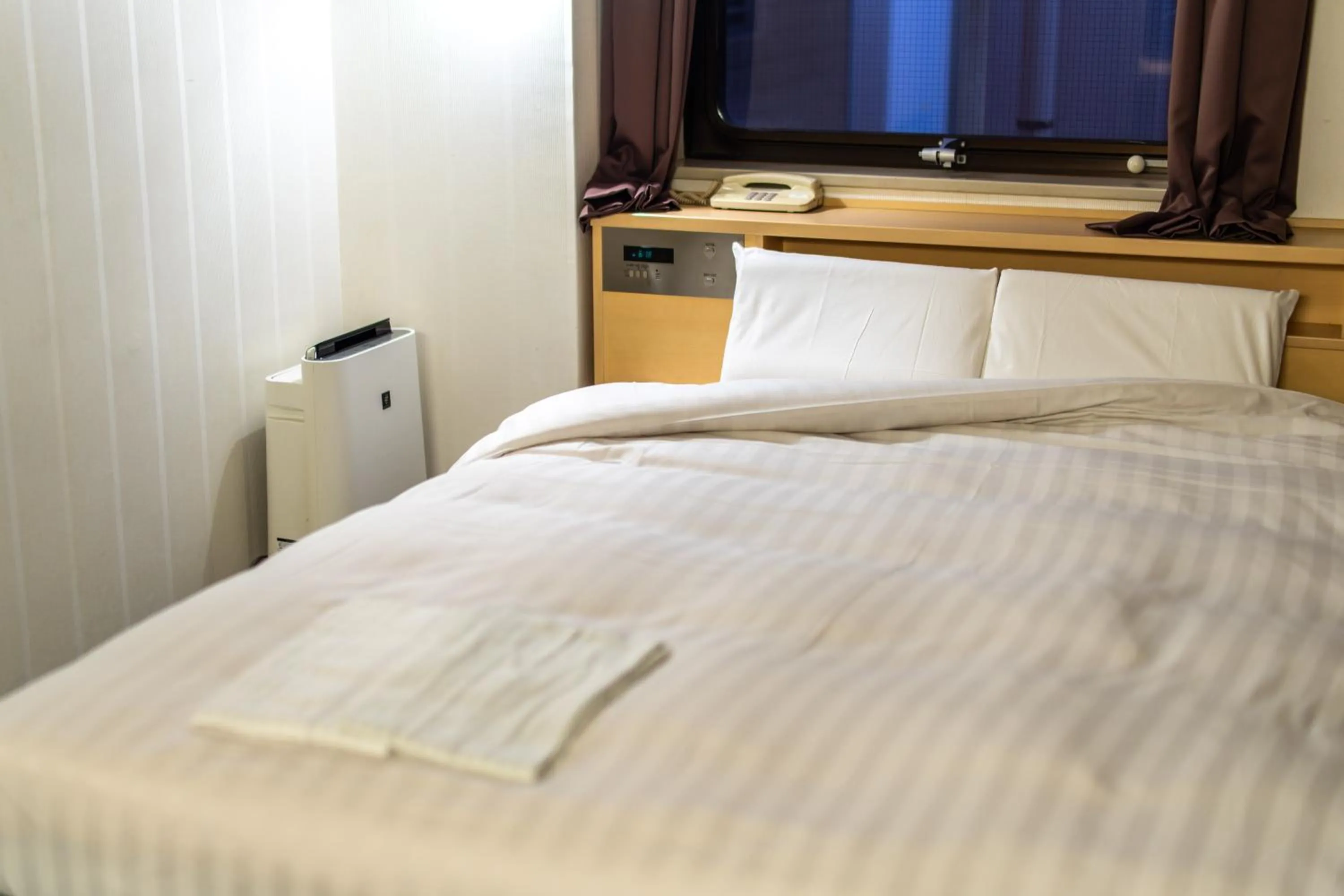 Bed in Ramada Encore by Wyndham Amagasaki