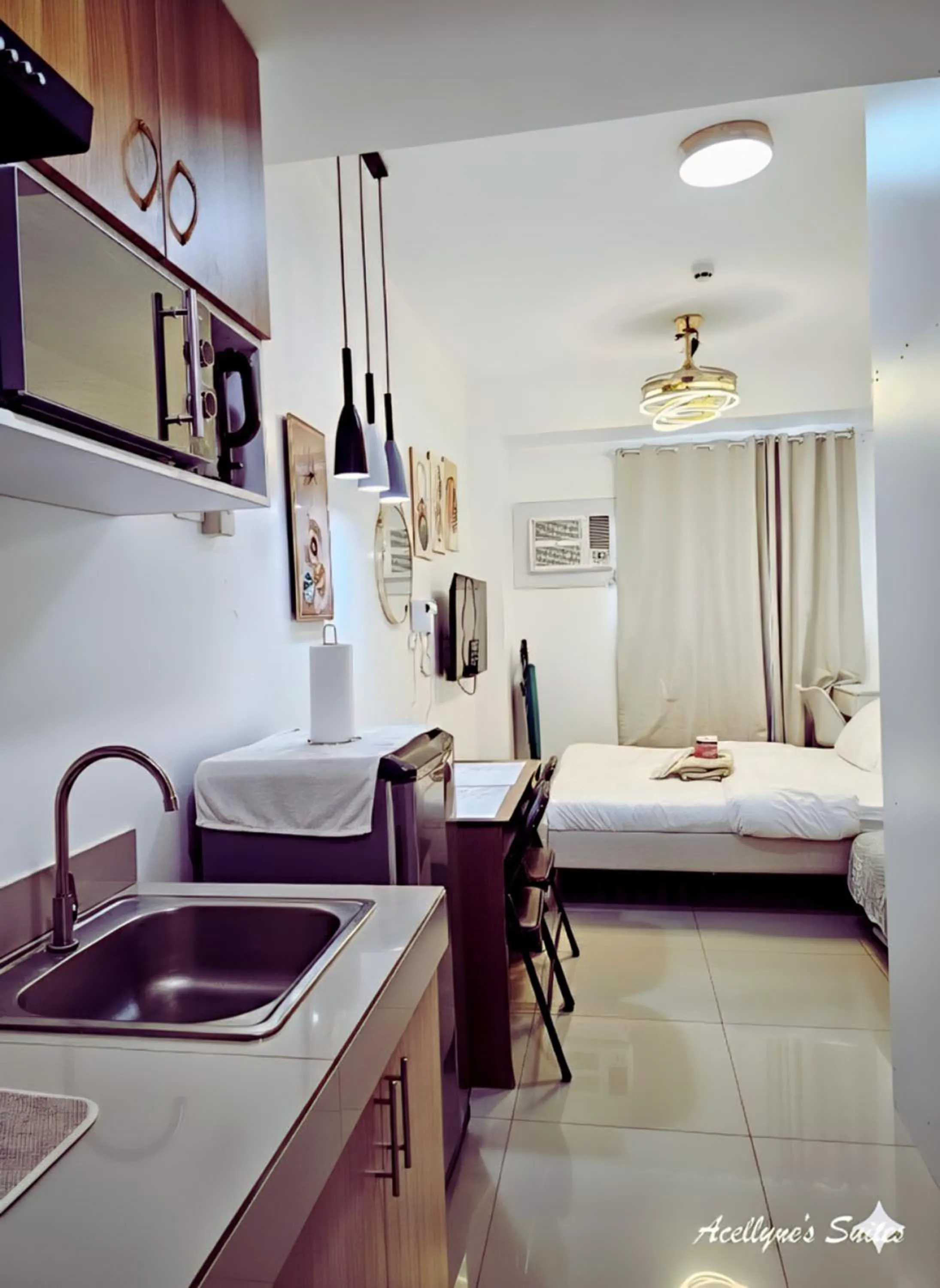 Kitchen or kitchenette, Bed in Acellyne's Suites at Green 2 Residences with Netflix!